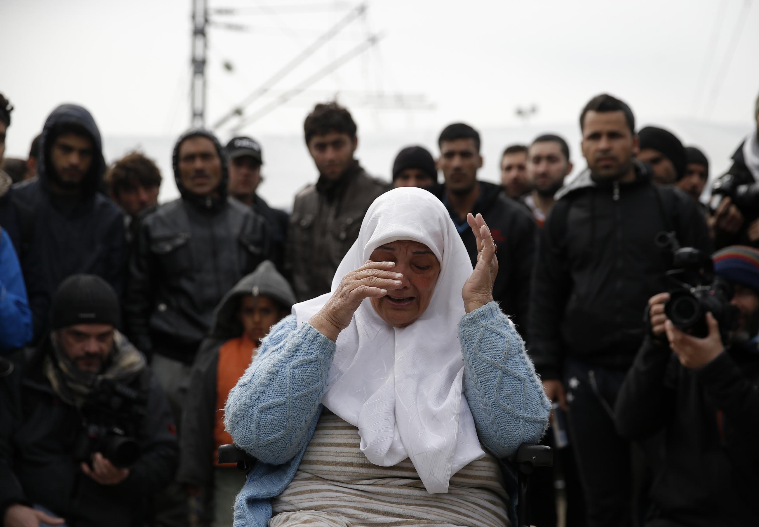 A migrant in a wheelchair cries during a protest at a makeshift camp at the Greek-Macedonian border near the village of Idomeni, Greece, March 27, 2016.