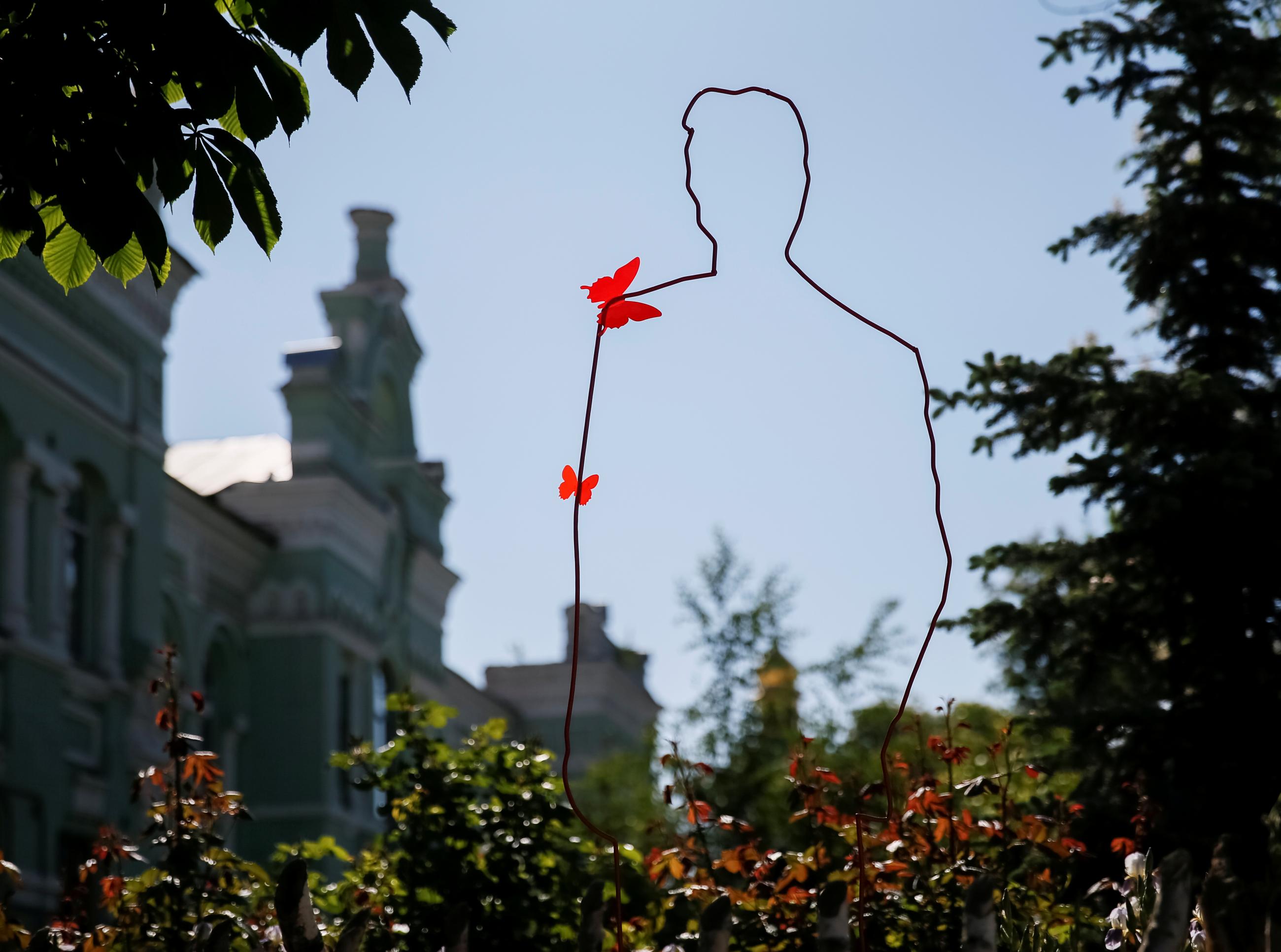 A metal silhouette symbolizing a victim of AIDS is seen during a ceremony near a monument in memory of AIDS victims as part of the commemoration of International AIDS Memorial Day in Kyiv, Ukraine, on May 19, 2017. 
