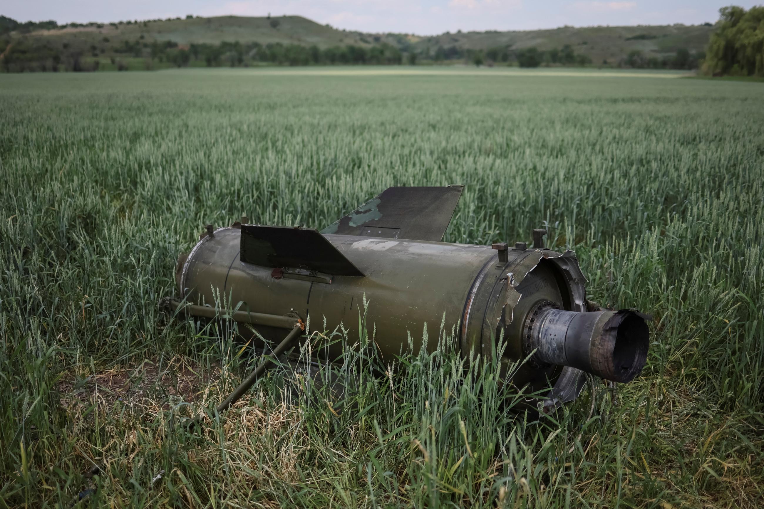 A large blackish-gray Russian Tochka-U ballistic missile sits in a field of wheat, during Russia's war on Ukraine, near the town of Soledar, in the Donetsk region Ukraine, on June 8, 2022. 