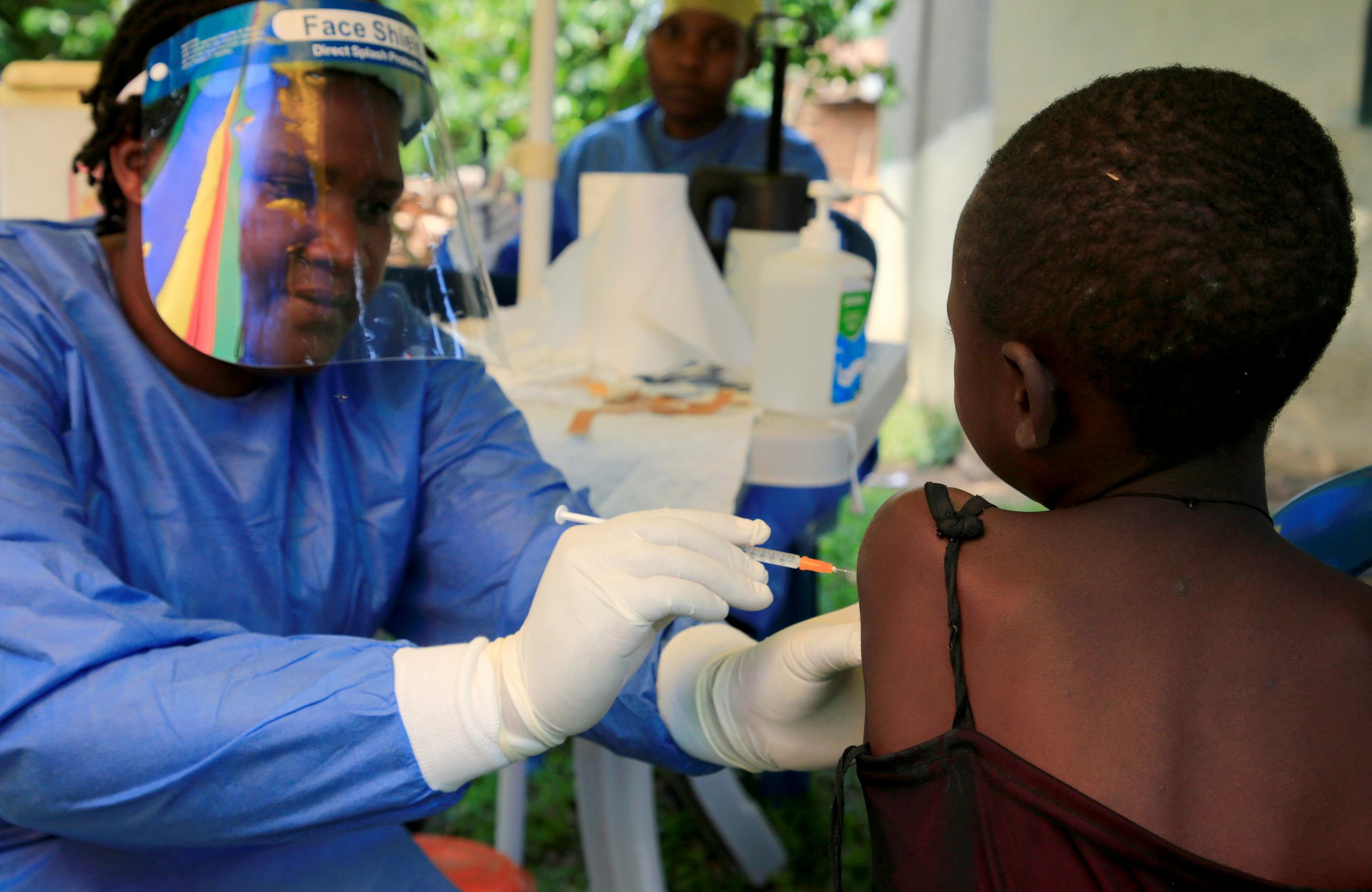 A Ugandan health worker administers ebola vaccine to a child in Kirembo village, near the border with the Democratic Republic of Congo in Kasese district, Uganda, on June 16, 2019. 