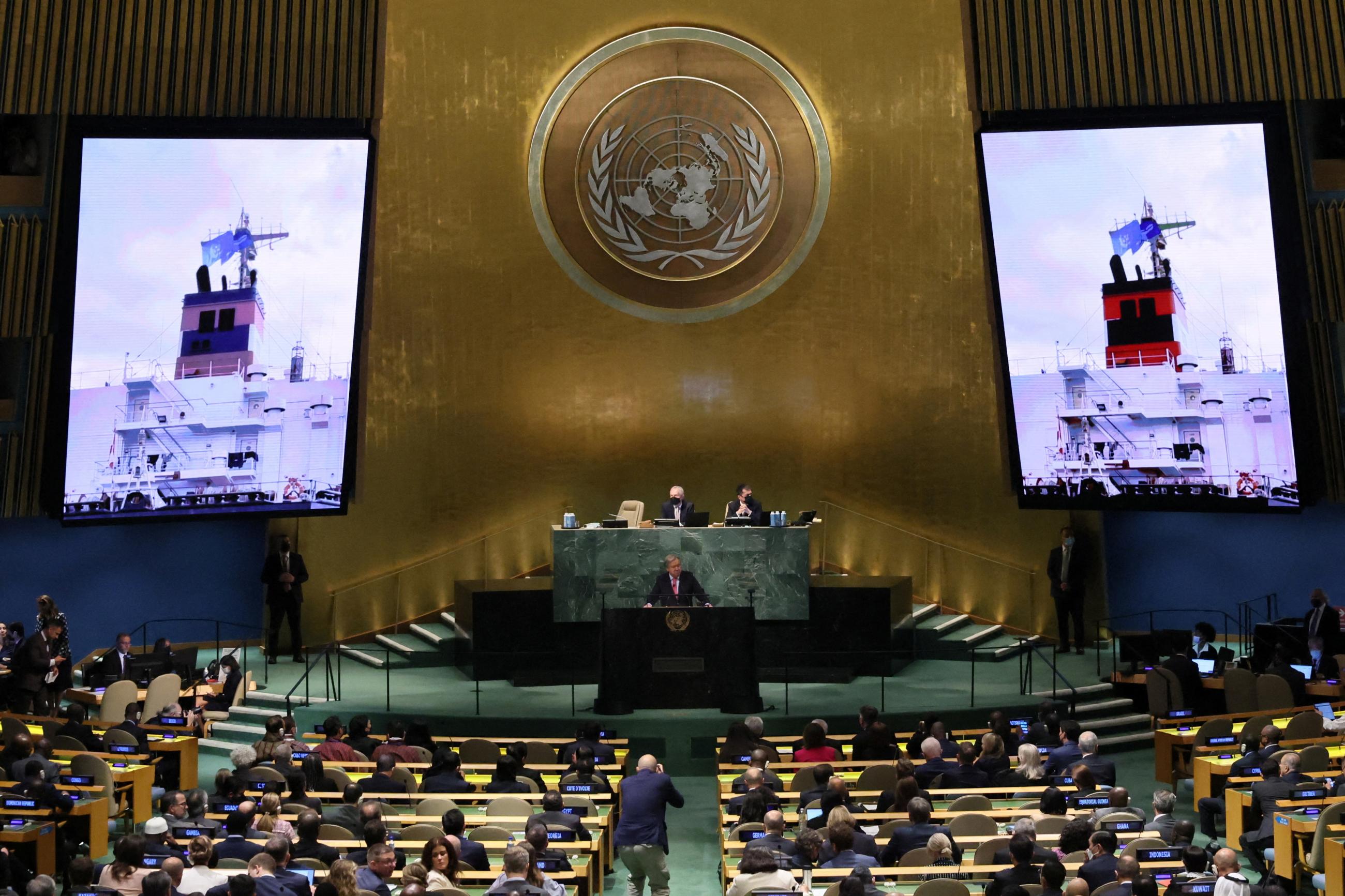 UN Secretary-General António Guterres displays on two giant screens in a large assembly hall images of a cargo ship of Ukrainian grain at the 77th Session of the UN General Assembly, at UN Headquarters in New York, on September 20, 2022.