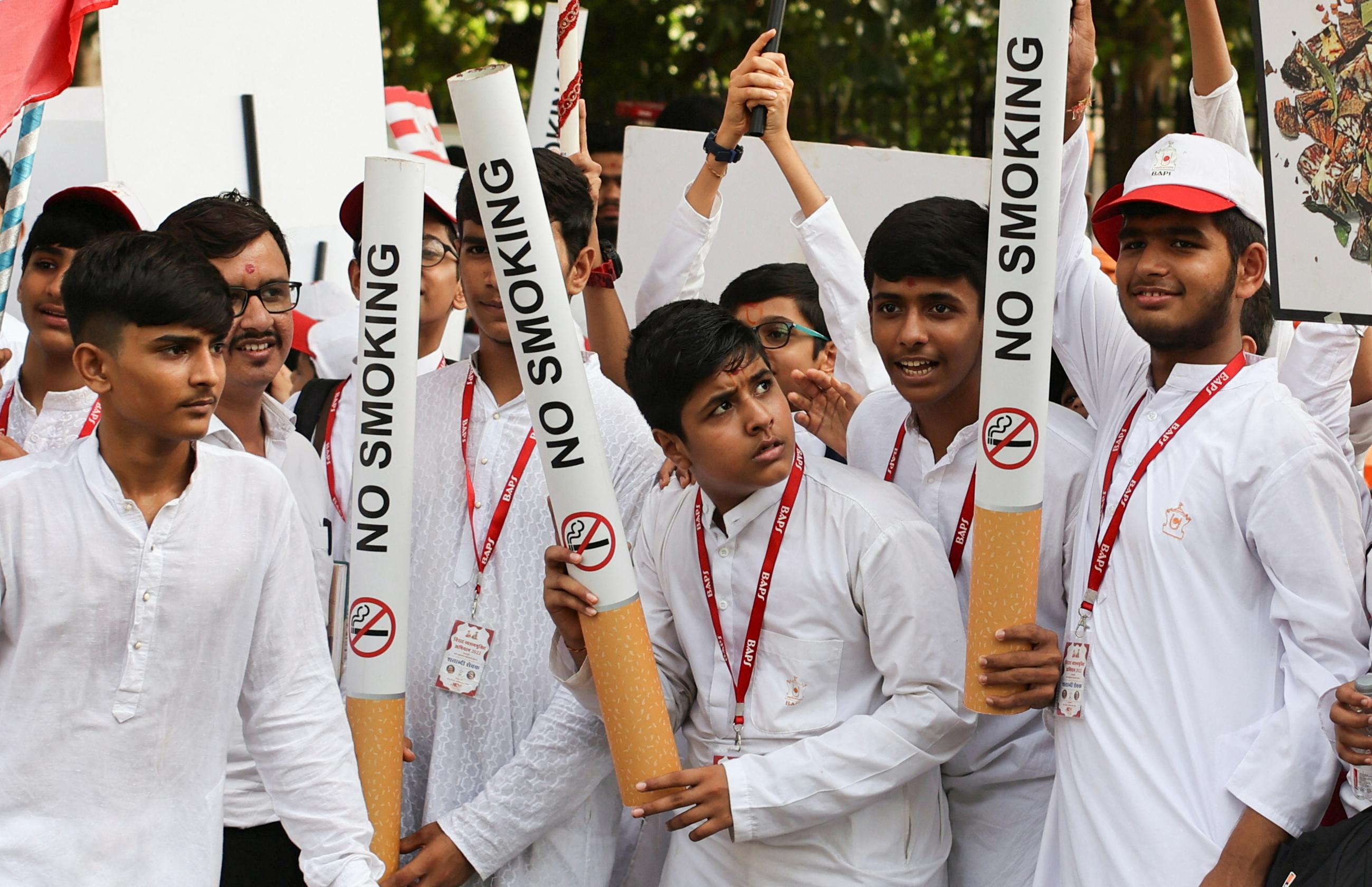 Students hold cigarette replicas to spread awareness on World No Tobacco Day in Mumbai, India, on May 31, 2022. REUTERS/Francis Mascarenhas