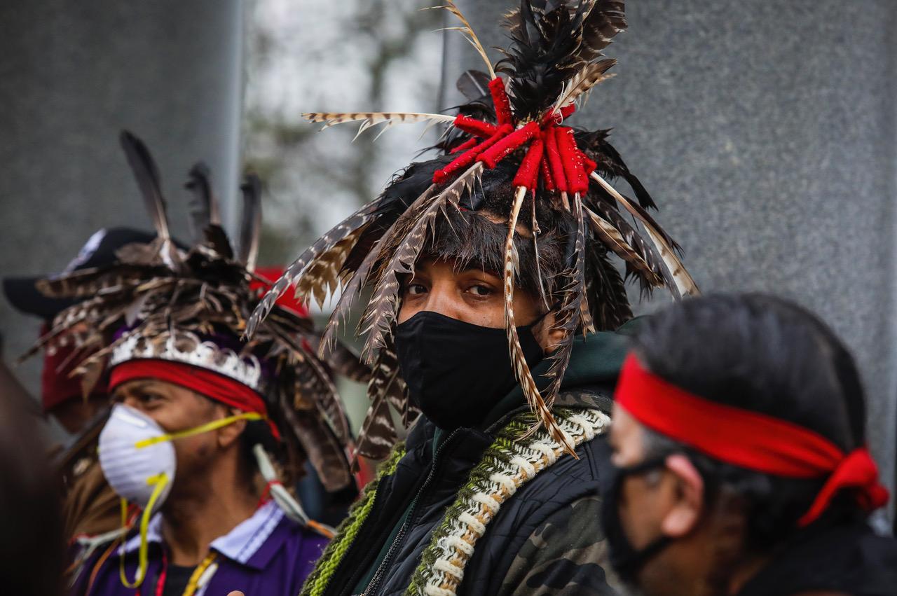 A demonstrator at Plymouth Rock on the 50th Anniversary of the National Day of Mourning, a reminder of the genocide of millions of Native People, in Plymouth, Massachusetts, November 2020. 