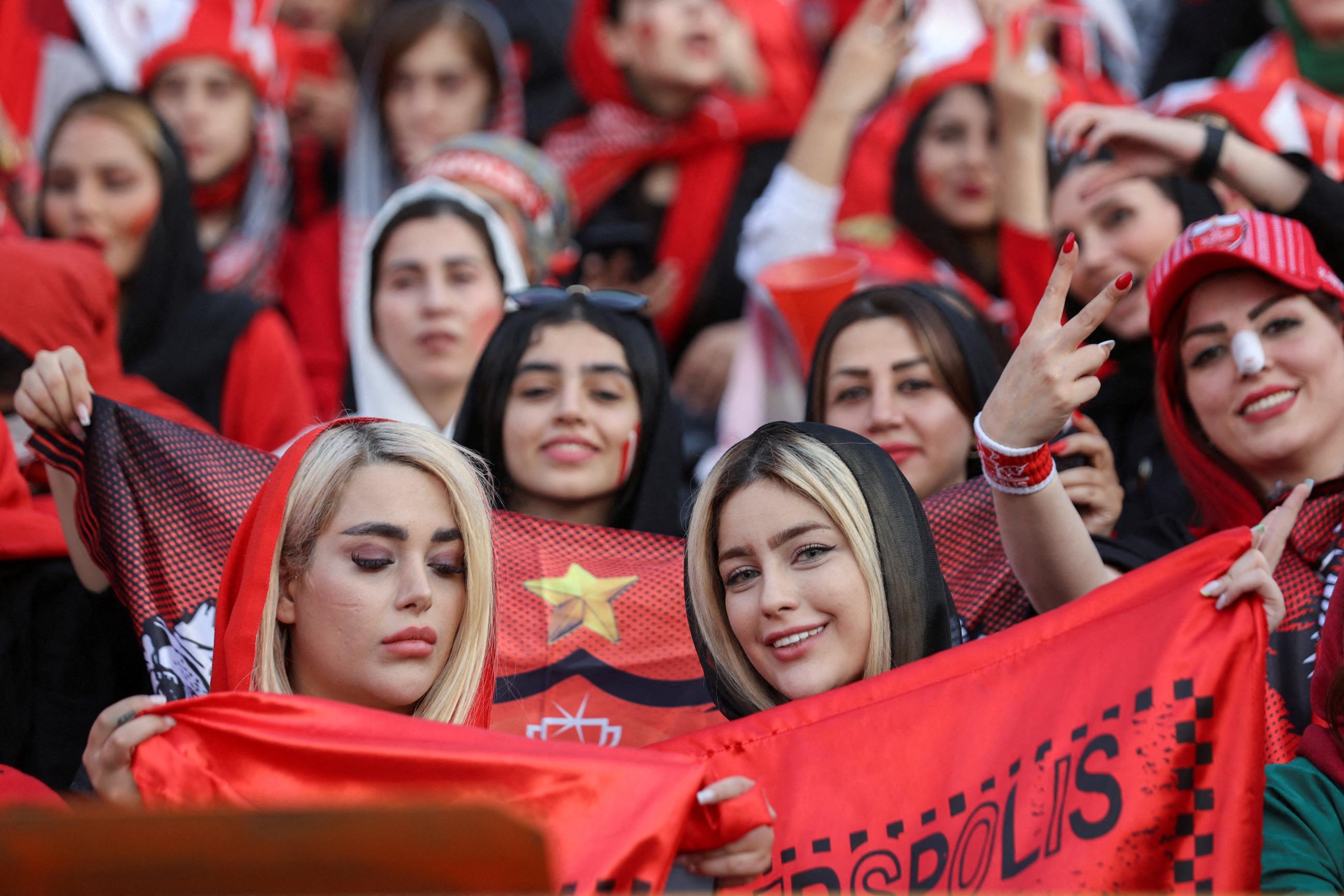 Women soccer fans, many dressed in red, attend a match for Iran's Premier League at Azadi Stadium in Tehran, Iran, on August 31, 2022.