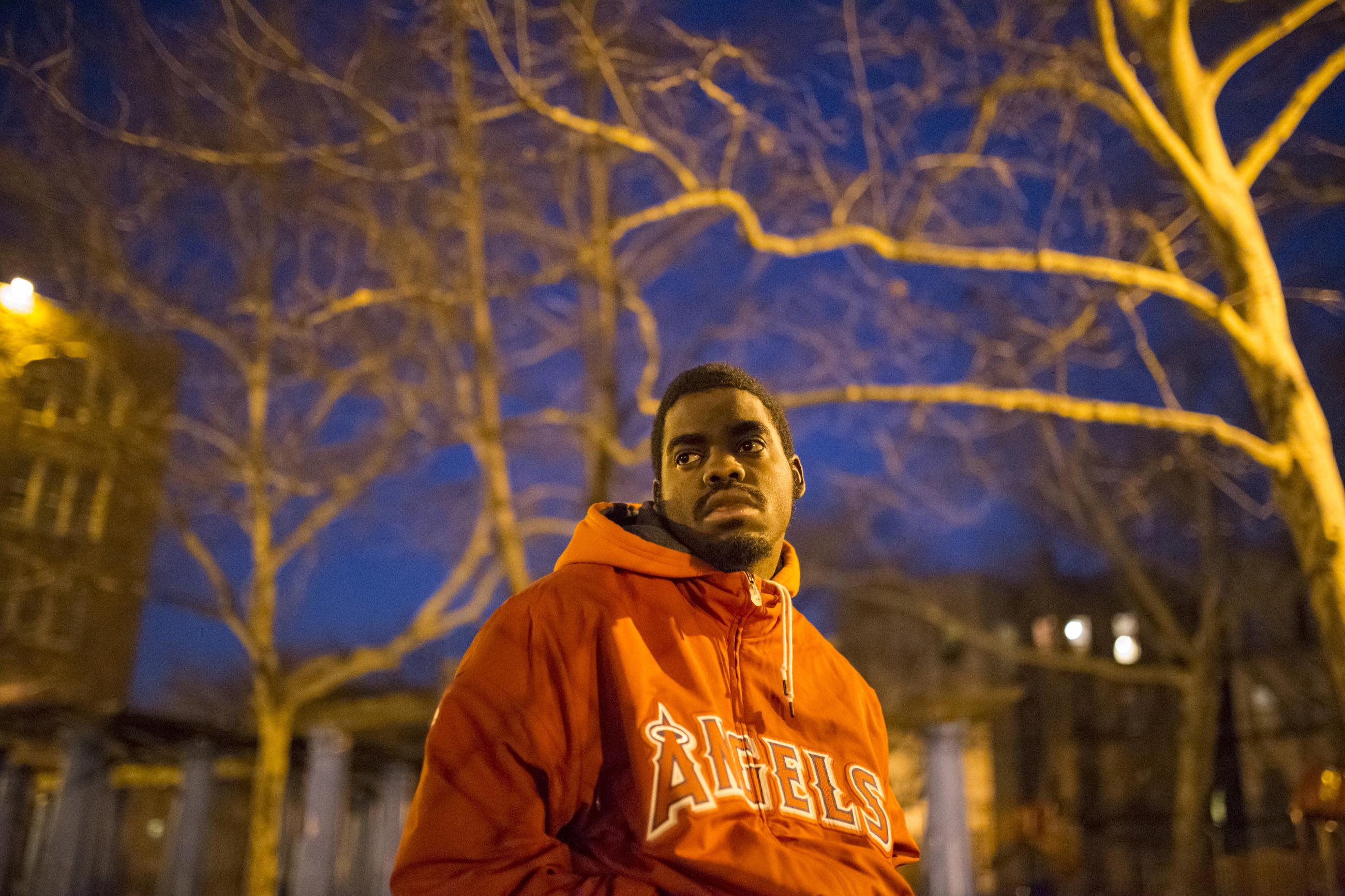 Eric Harmon, 20, was incarcerated on Rikers Island from 2010 to 2011 when he was 16 on a drug charge. Here, he poses in an orange sweatshirt on a playground near his home in the Bronx, New York, on January 17, 2015. 