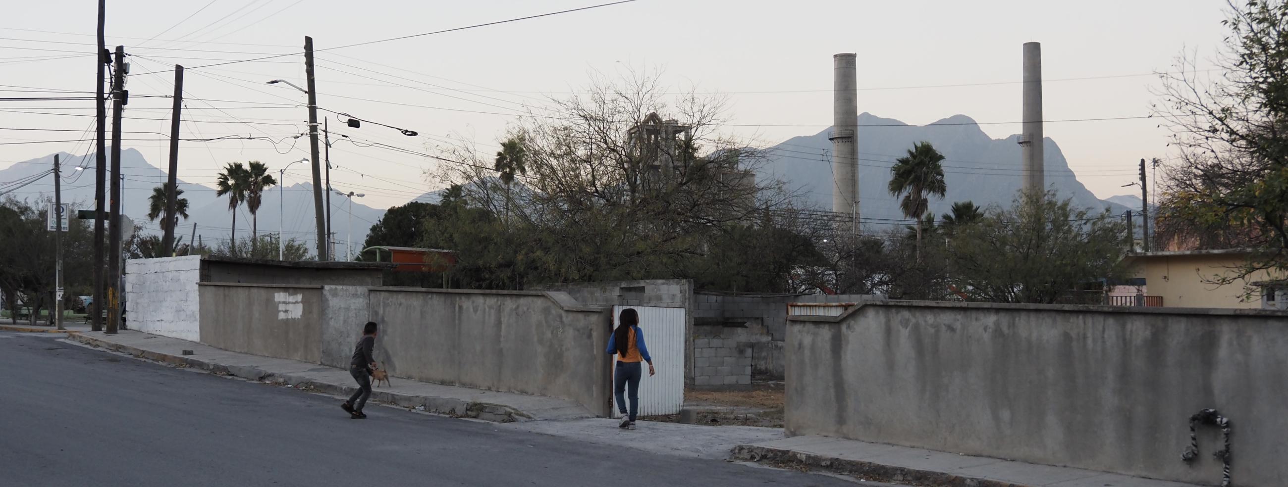 Two kids playing in downtown Hidalgo, overlooking the CEMEX cement factory.