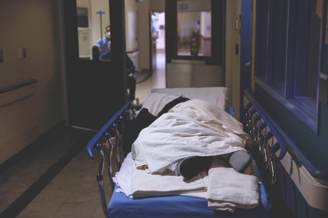 A patient rests on a gurney, waiting to be seen in the emergency room waiting area at Providence Mission Hospital in Mission Viejo, California, on January 27, 2022. 