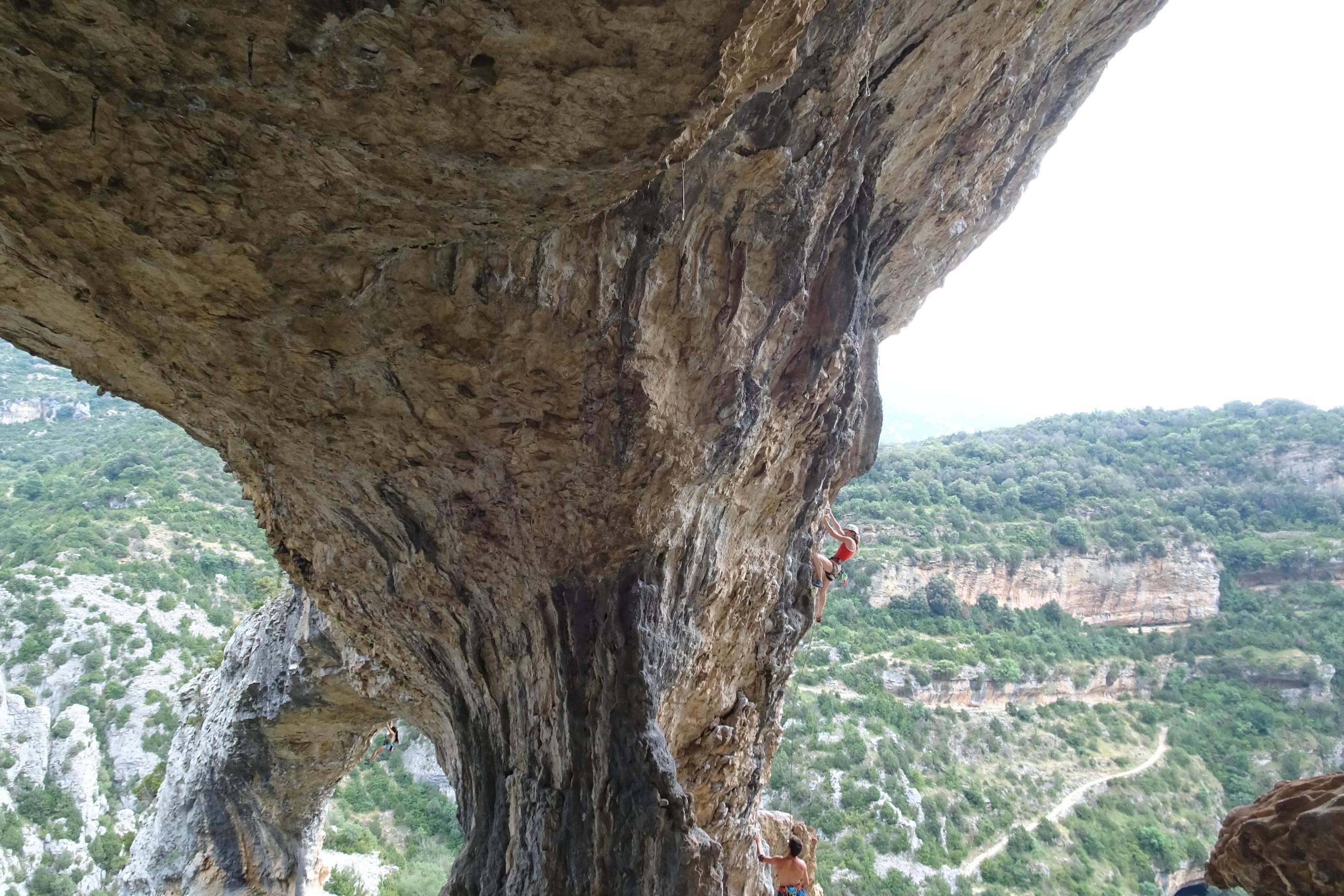 Ott, in her first trimester, in the red top (center) with her partner, Chaz (bottom right), belaying while they were rock climbing in Spain in 2017.