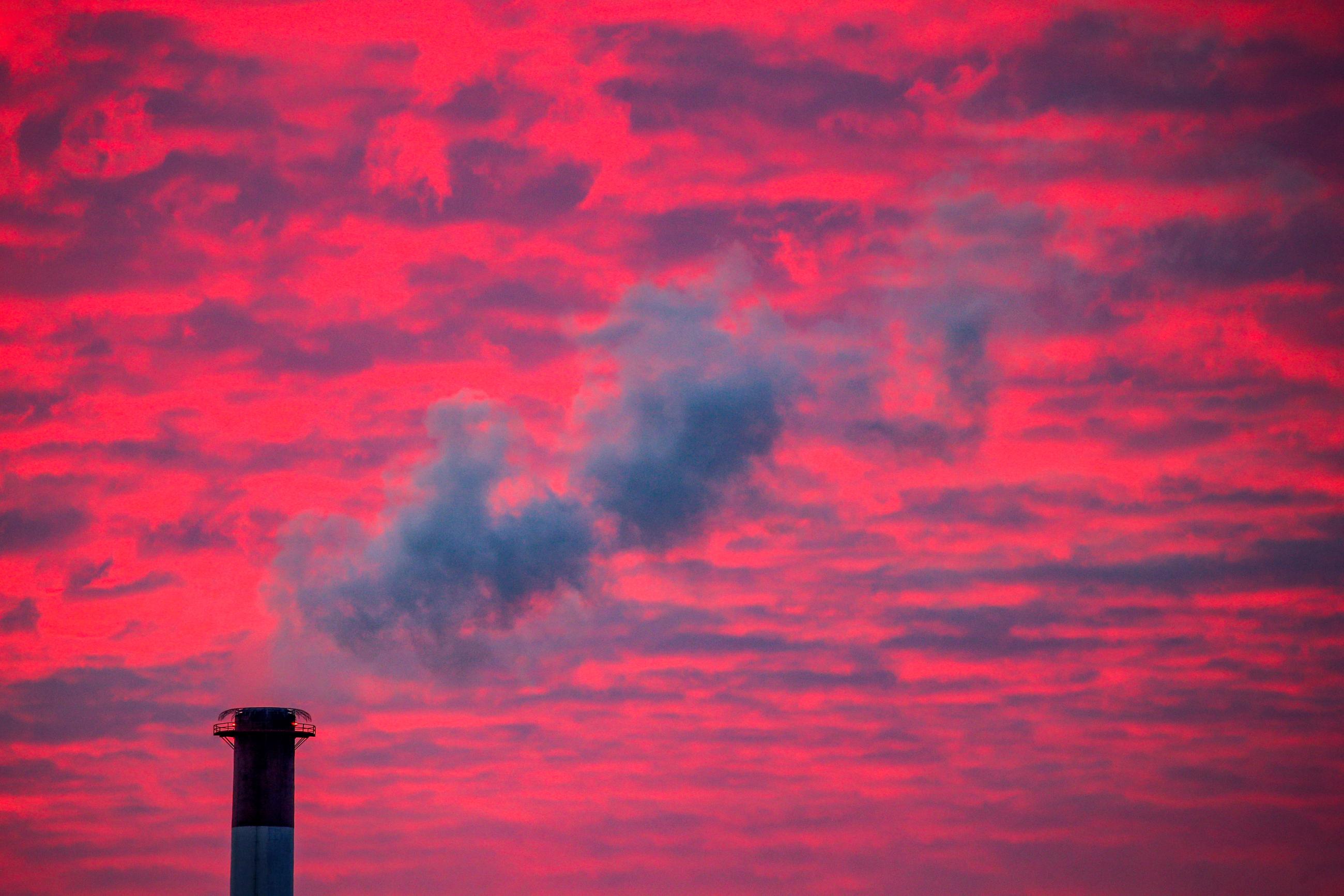 Steam rises from a smoke stack at sunset in Lansing, Michigan, U.S., January 17, 2018. REUTERS/Brendan McDermid