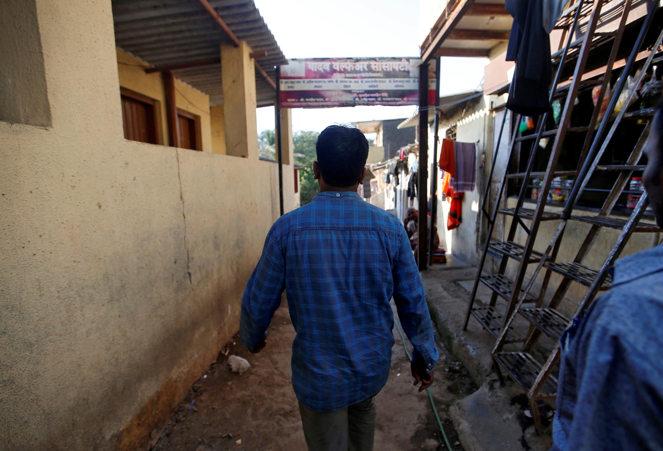 The father of a boy who committed suicide after he was sexually assaulted last year, walks in an alley outside his house in Mumbai, India, on April 26, 2018. 