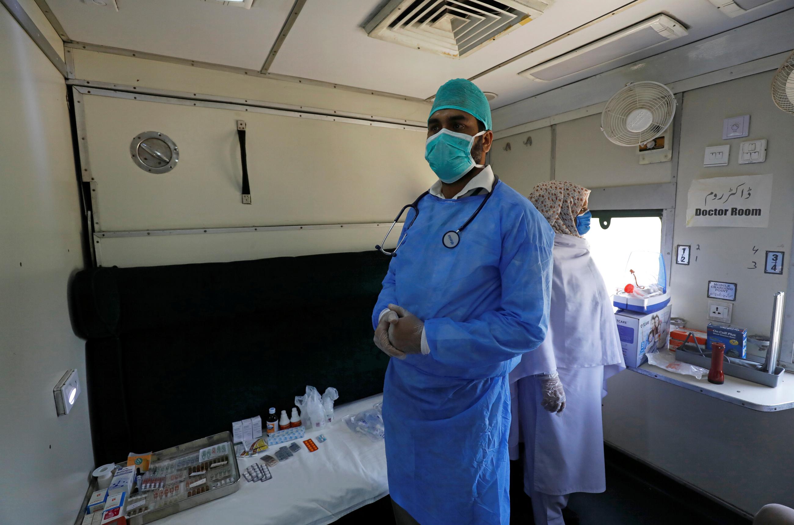 A doctor and nurse wear protective masks as they stand in a passenger train's car, after the government turned it into a hospital and quarantine center following the outbreak of coronavirus disease (COVID-19), in Karachi, Pakistan, on March 31, 2020. REUTERS/Akhtar Soomro