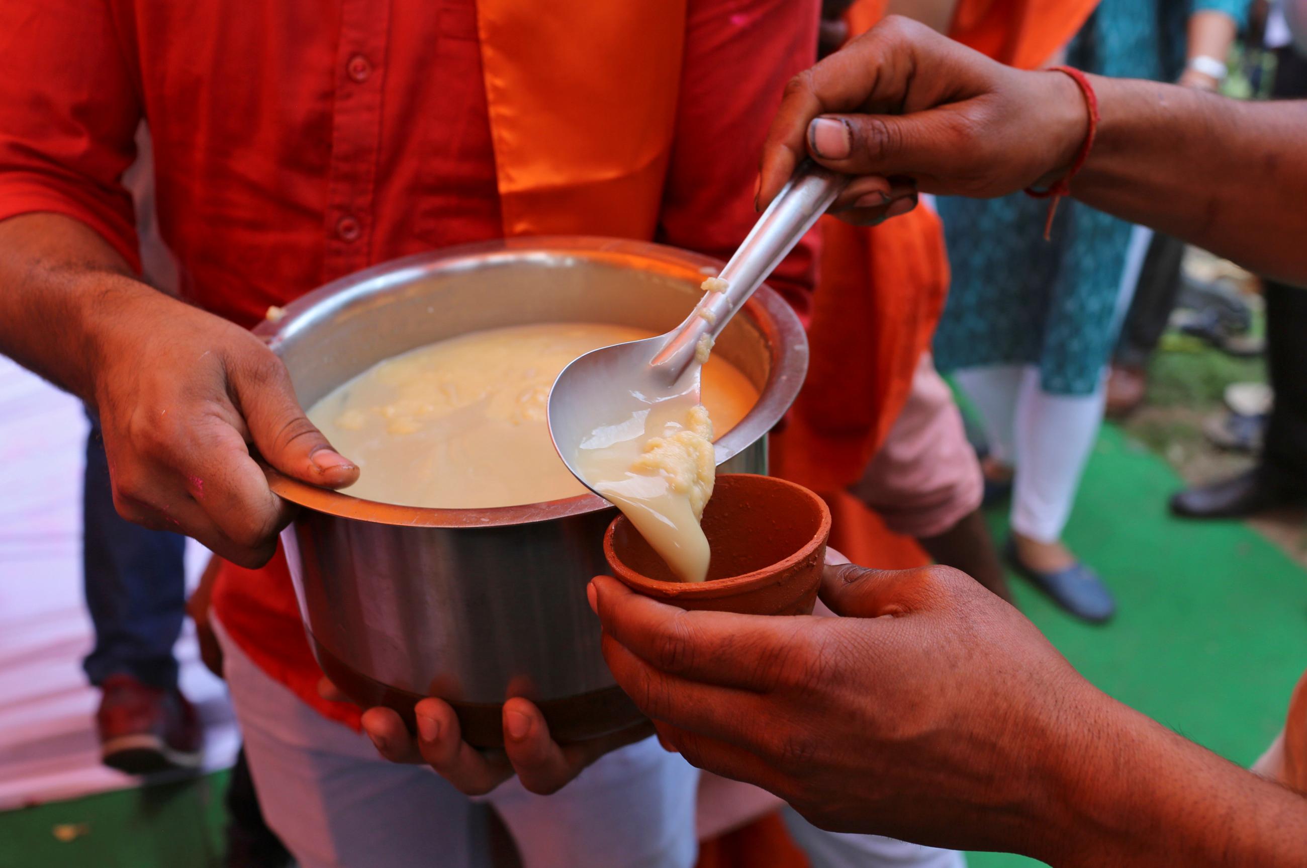 Members of All India Hindu Mahasabha serve a traditional drink with cow urine as an ingredient during a gaumutra (cow urine) party, which according to them helps in warding off coronavirus disease (COVID-19), in New Delhi, India March 14, 2020.