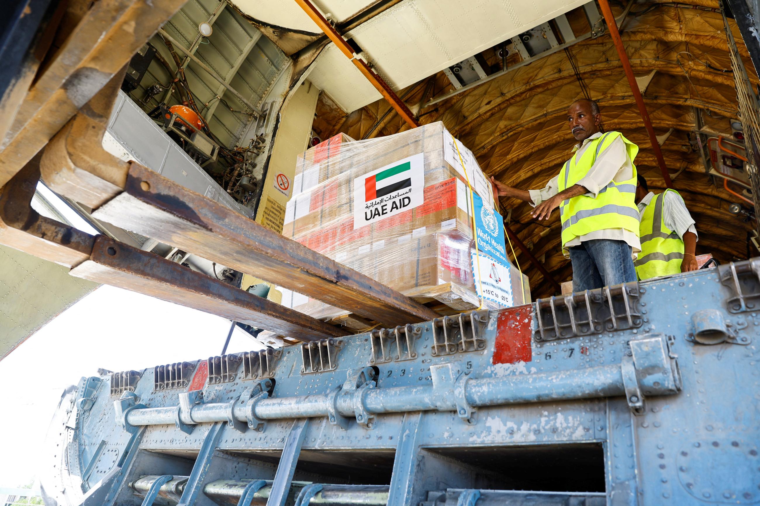 Workers unload aid from the WHO and UAE-AID from United Arab Emirates at the Port Sudan International Airport, Port Sudan, Sudan, on May 5, 2023.