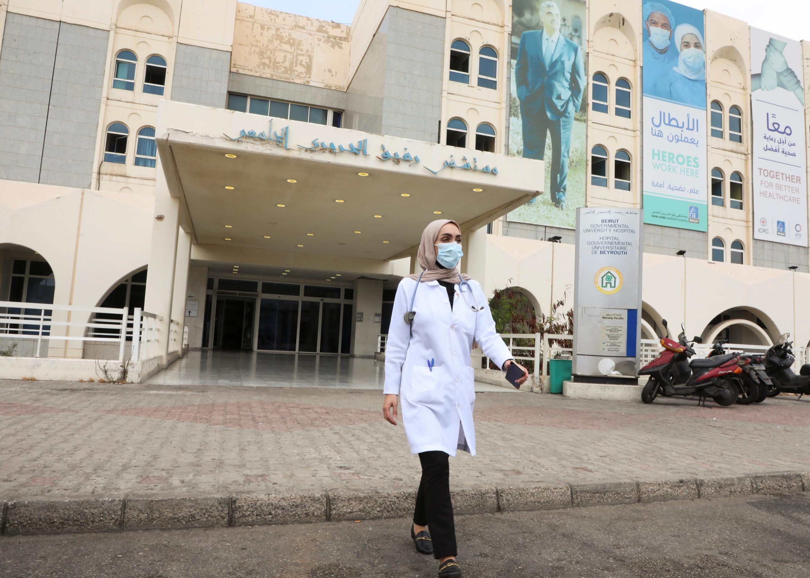 Israa Seblani, a doctor who was caught up in the Beirut Blast during a wedding photoshoot, walks outside Rafik Hariri University Hospital, in Beirut, Lebanon, on July 24, 2021.