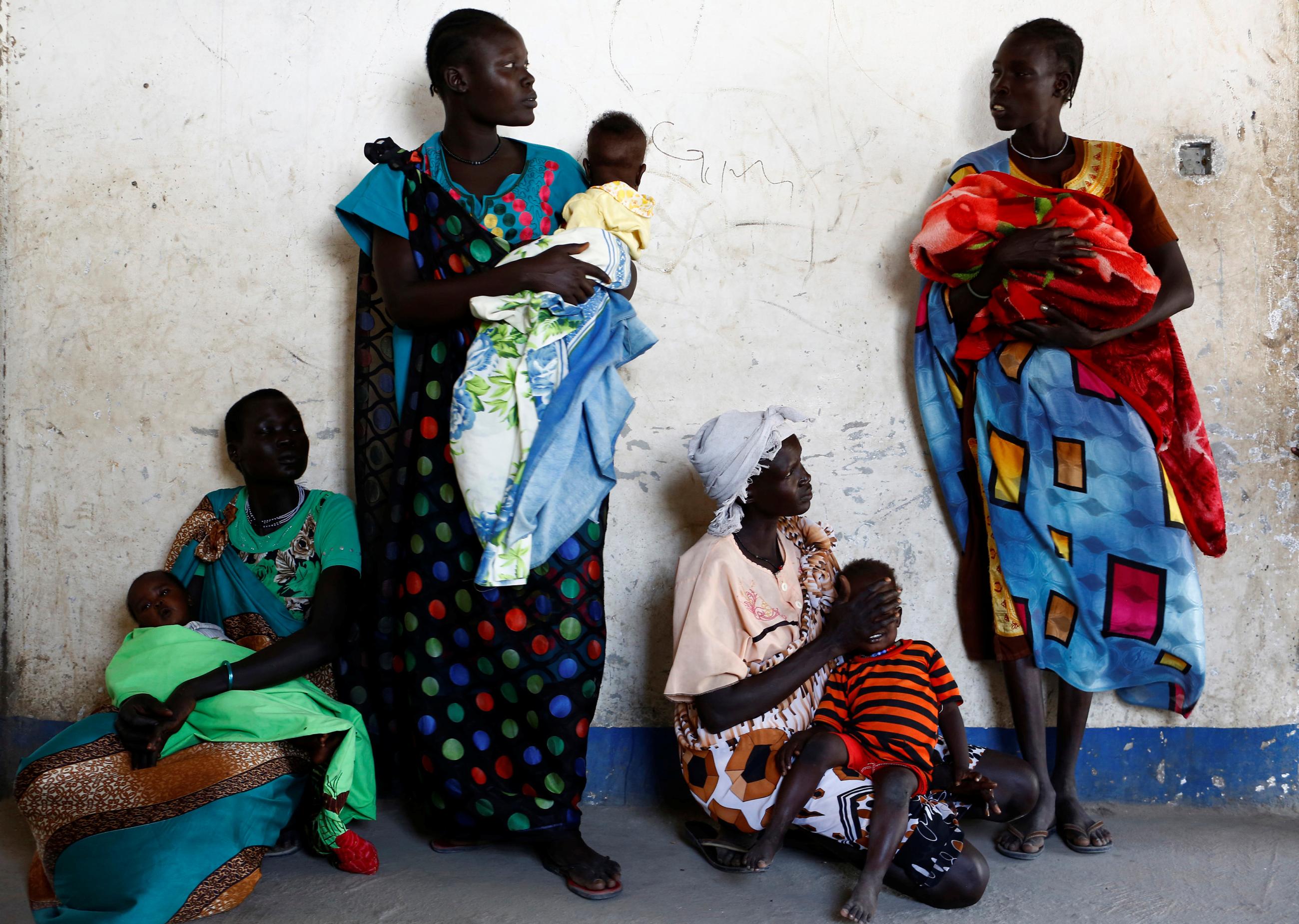 Women hold their babies as they wait for a medical check-up at a UNICEF-supported mobile health clinic in Nimini village, Unity State, South Sudan, on February 8, 2017.