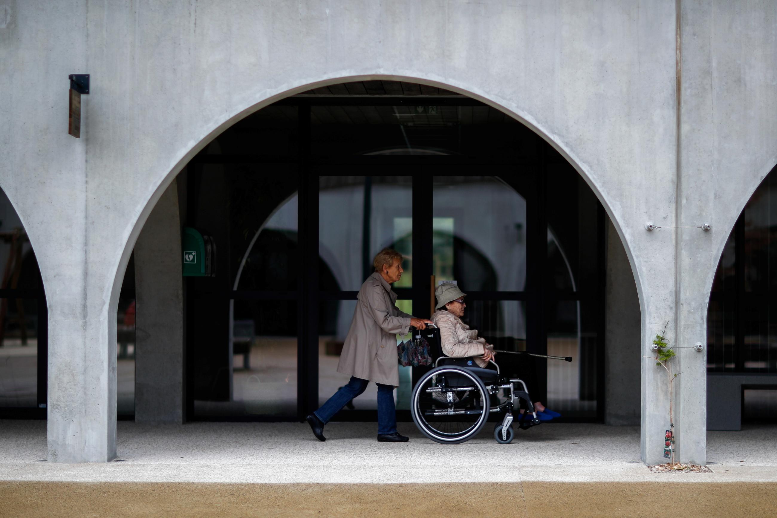 Alzheimer's patients Marie-Christiane pushes Jaqueline, ninety-two, on her wheelchair during a walk at the Village Landais Alzheimer site in Dax, France, September 24, 2020. 