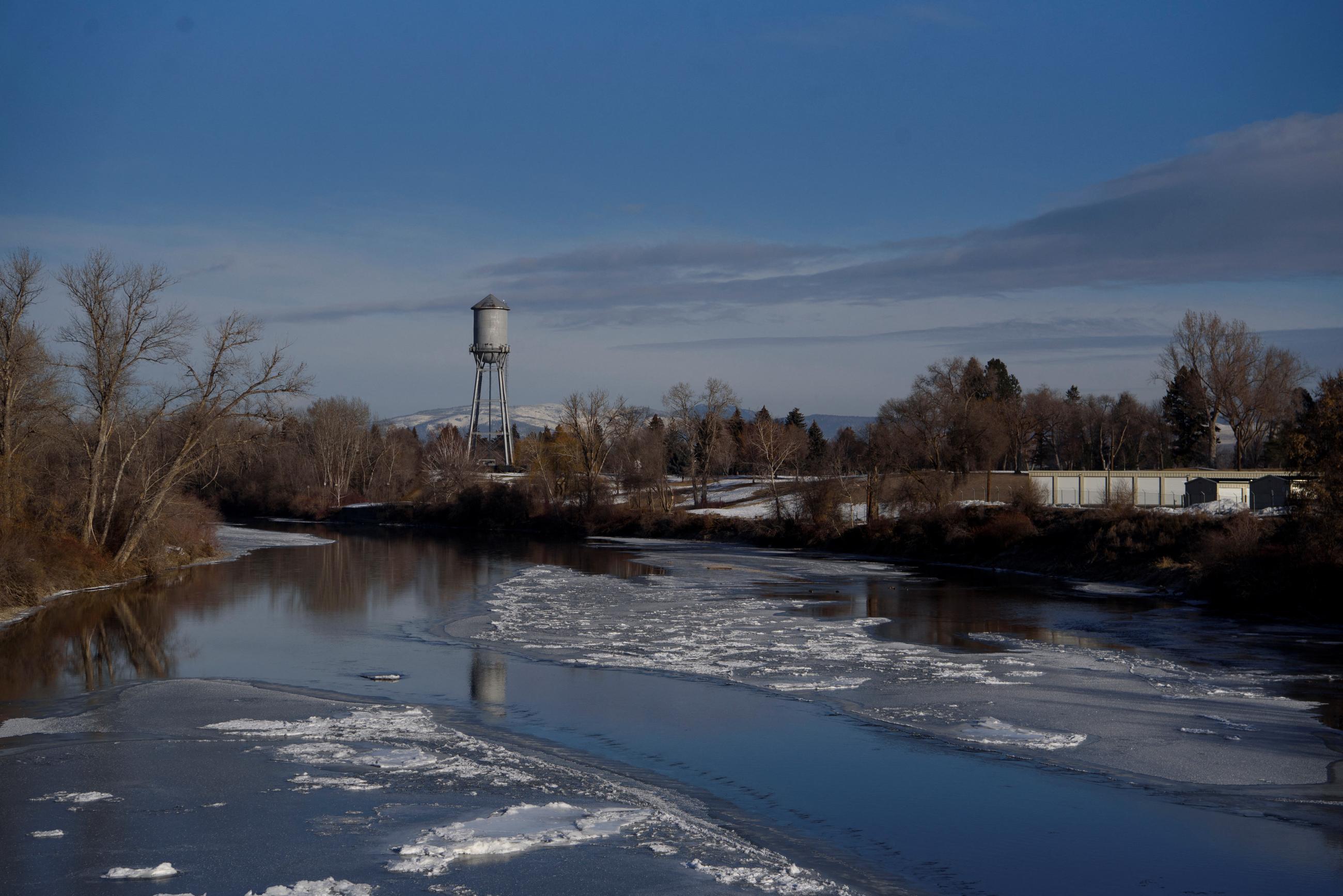 A water tower is reflected in icy water in Missoula, Montana, U.S. February 25, 2023. Montana is a largely rural state.