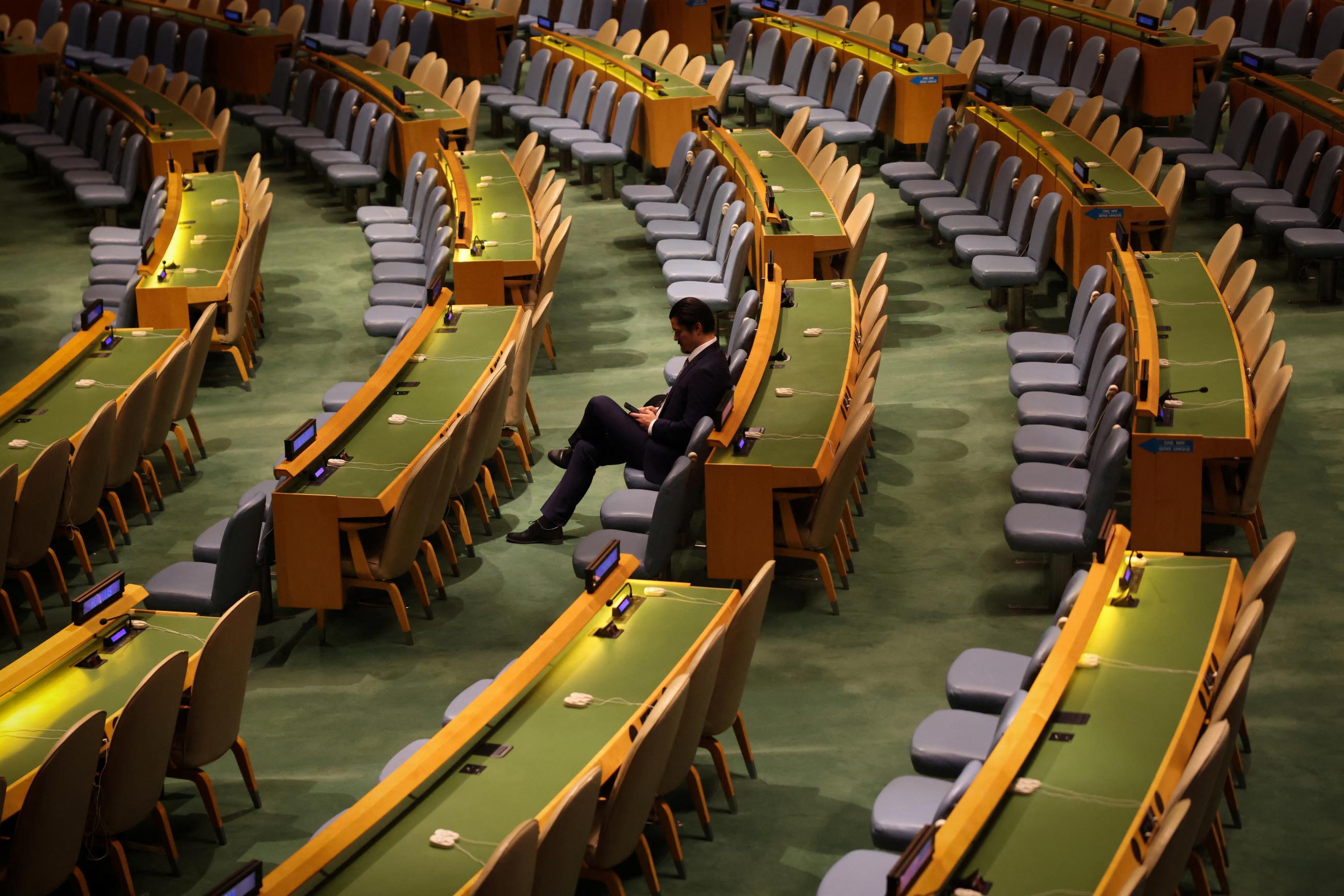 A delegate sits alone ahead of a high-level meeting of the United Nations General Assembly to mark one year since Russia invaded Ukraine and to consider the adoption of a resolution on Ukraine, at U.N. headquarters in New York City, New York, U.S., February 23, 2023.