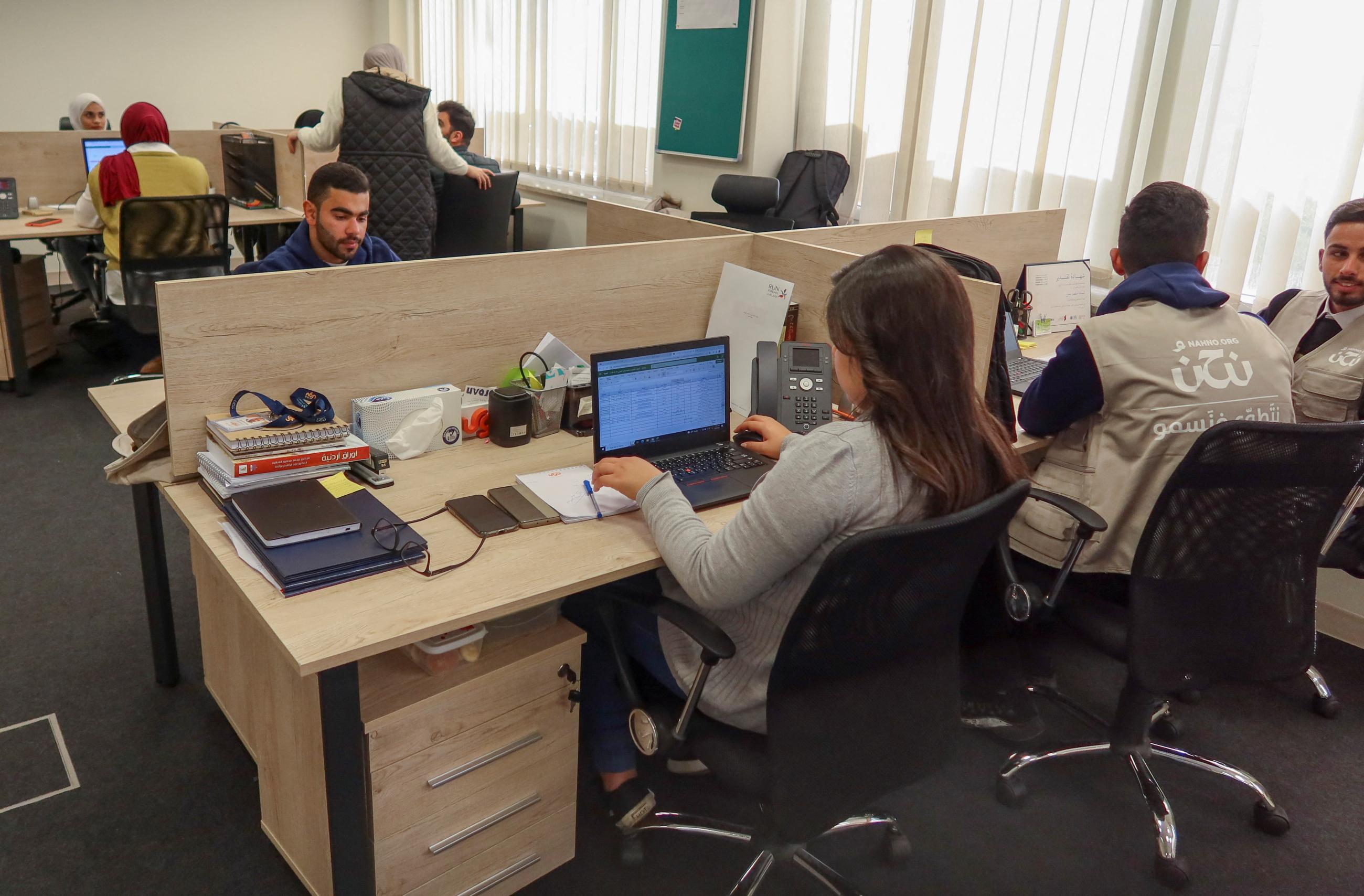 Staff members of "Nahno," an online platform linking volunteers with opportunities, work in the office in Amman, Jordan, February 20, 2023.