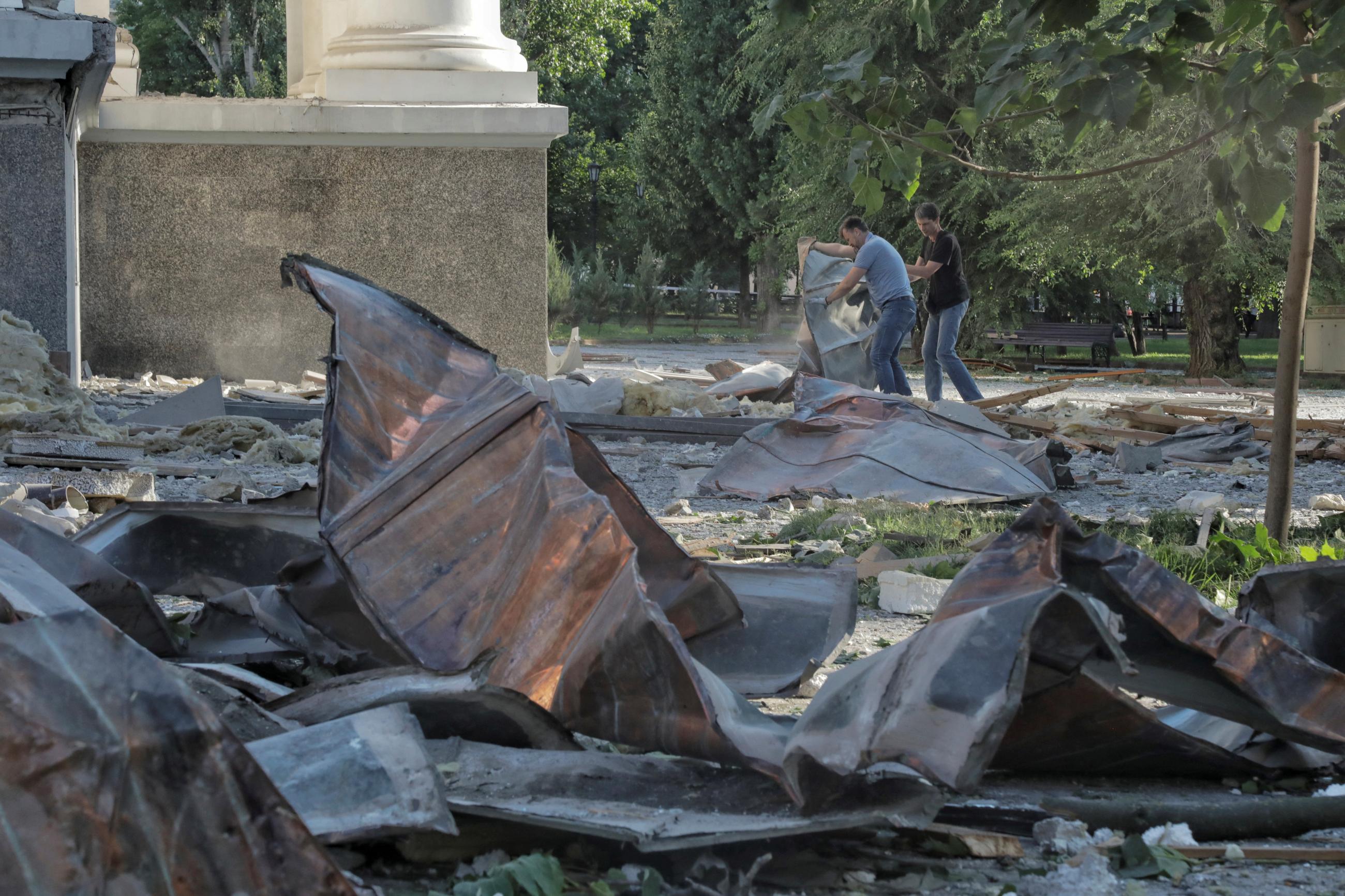 People remove debris at a site of the Transfiguration Cathedral damaged during a Russian missile strike amid Russia's attack on Ukraine, in Odesa, Ukraine, July 23, 2023.