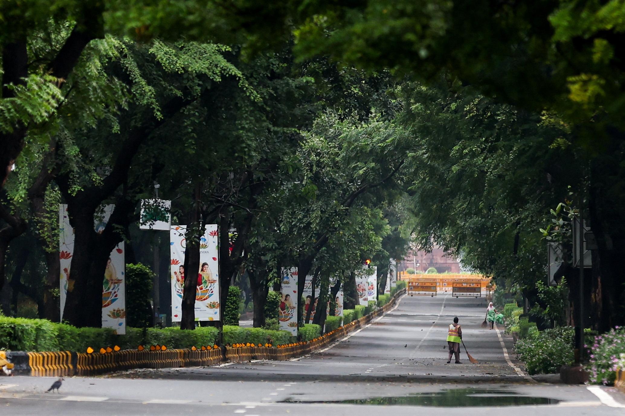 Sanitation workers clean empty streets, on the second day of the G20 summit in New Delhi, India, September 10, 2023.