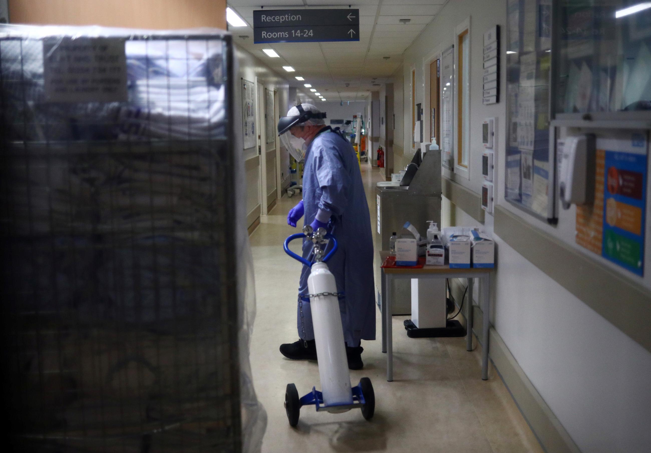 A medical worker moves an oxygen tank in the Critical Care Unit at The Royal Blackburn Teaching Hospital in East Lancashire, following the outbreak of the coronavirus disease (COVID-19), in Blackburn, Britain, May 14, 2020.