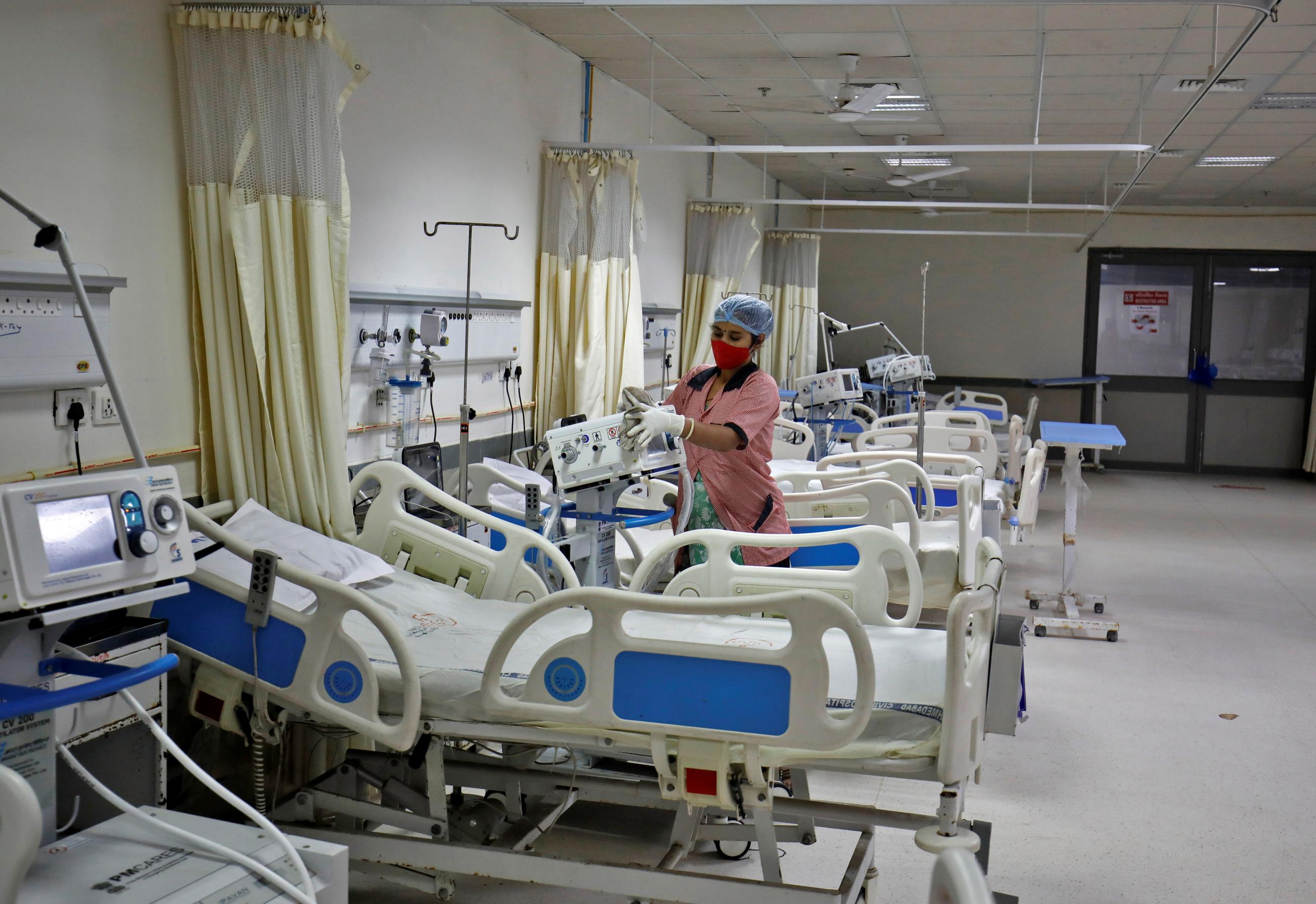 A staff member cleans medical equipment inside a ward at the Civil Hospital in Ahmedabad, India, December 6, 2021.