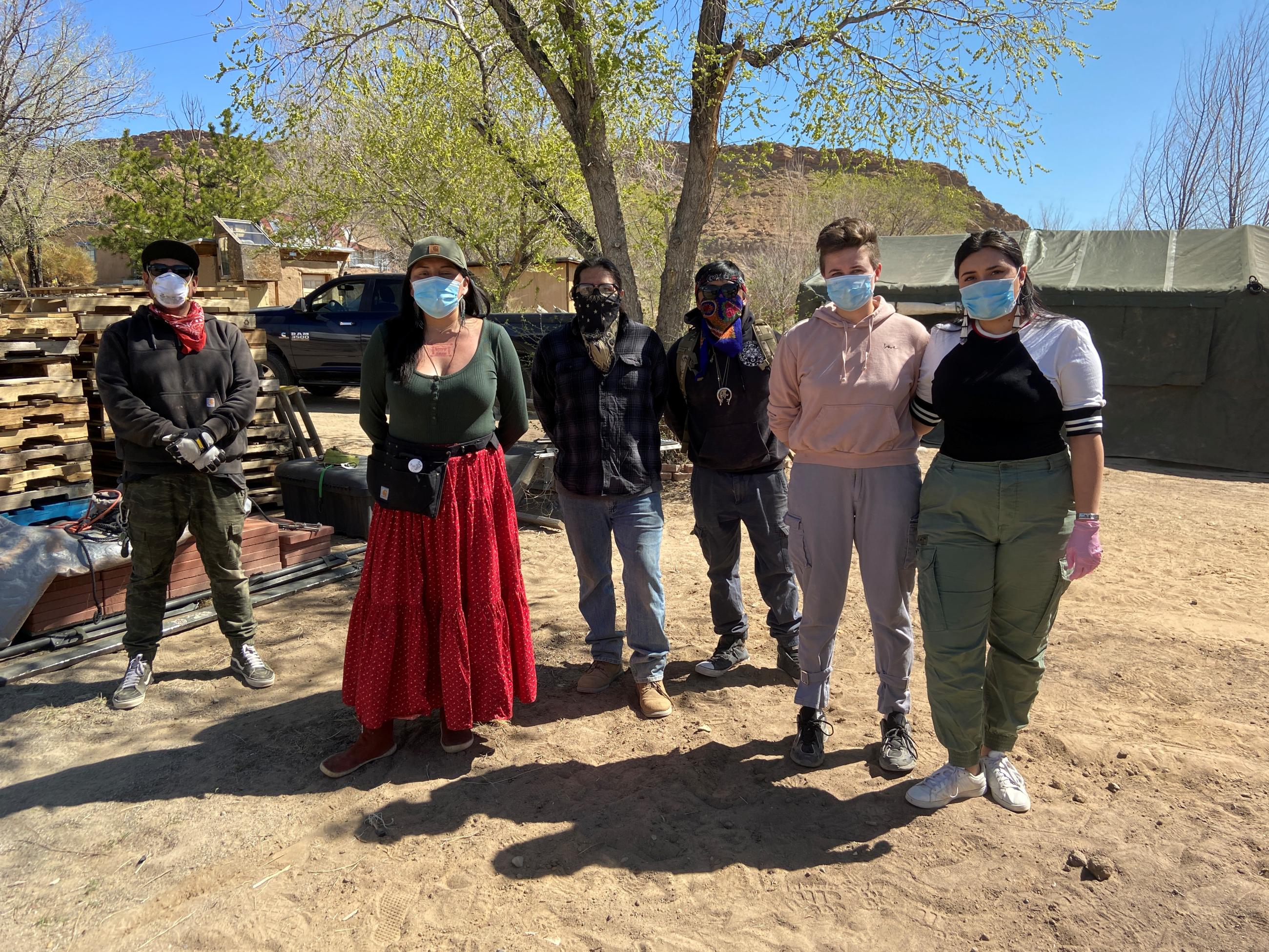 Relief workers pose at a farm.