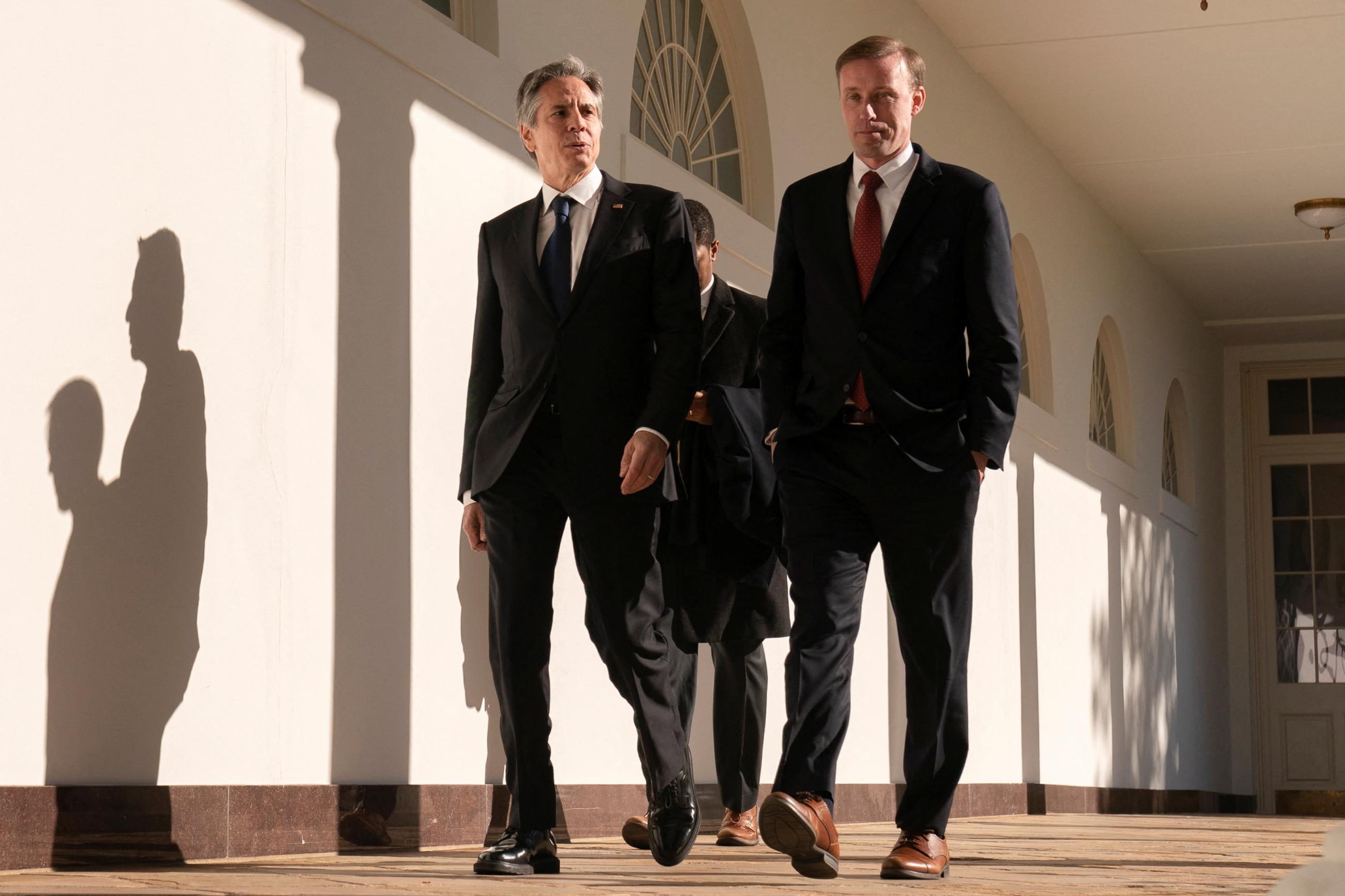 U.S. Secretary of State Antony Blinken and White House National Security Advisor Jake Sullivan walk along the Colonnade of the White House in Washington, DC, on December 1, 2022