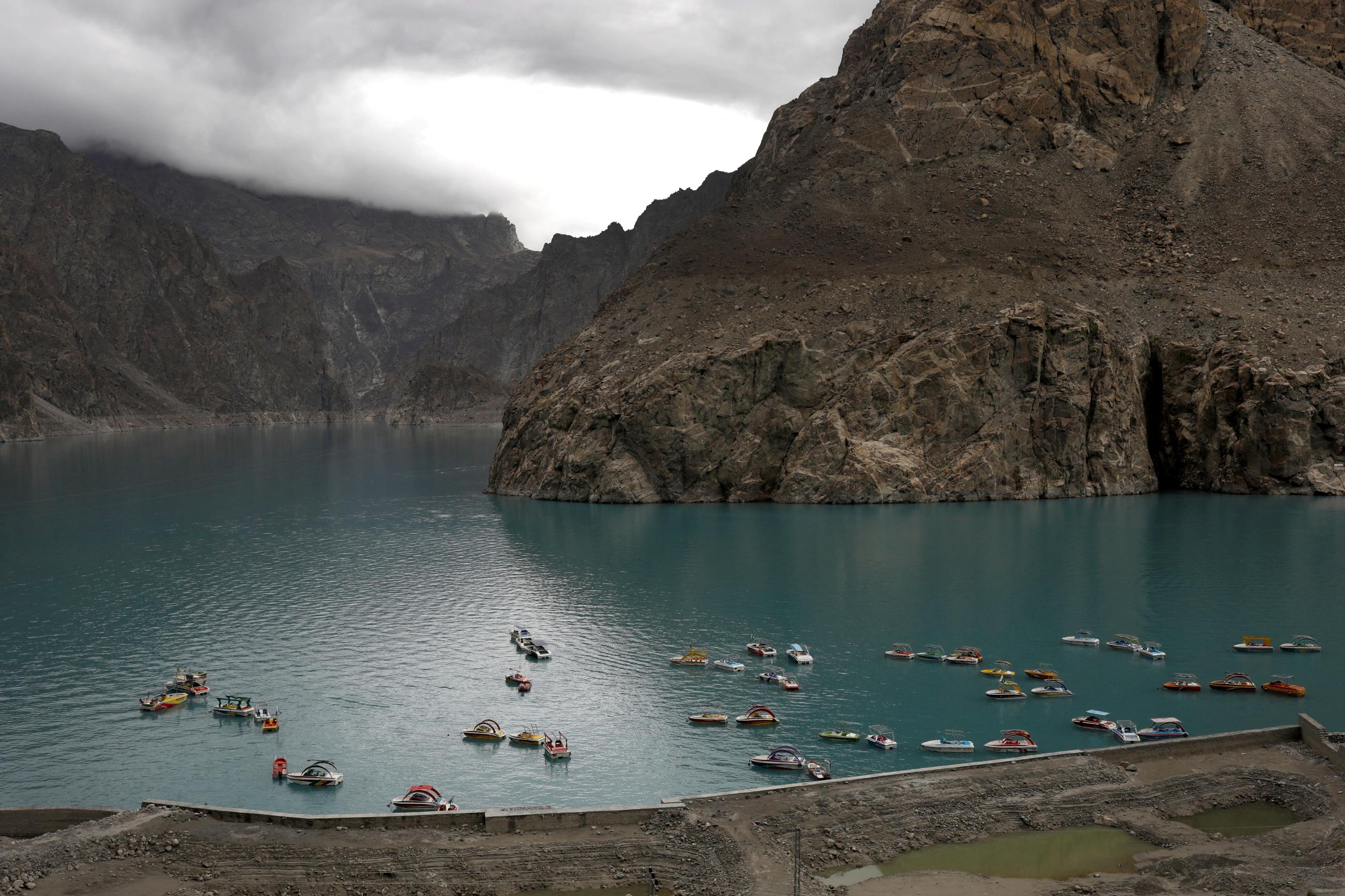 Boats gather on Attabad lake, which was formed due to a landslide in Attabad, in the Karakoram mountain range in the Gilgit-Baltistan region of Pakistan, October 8, 2023. Fifteen million people worldwide are at risk of glacial lake flooding, with 2 million of them in Pakistan