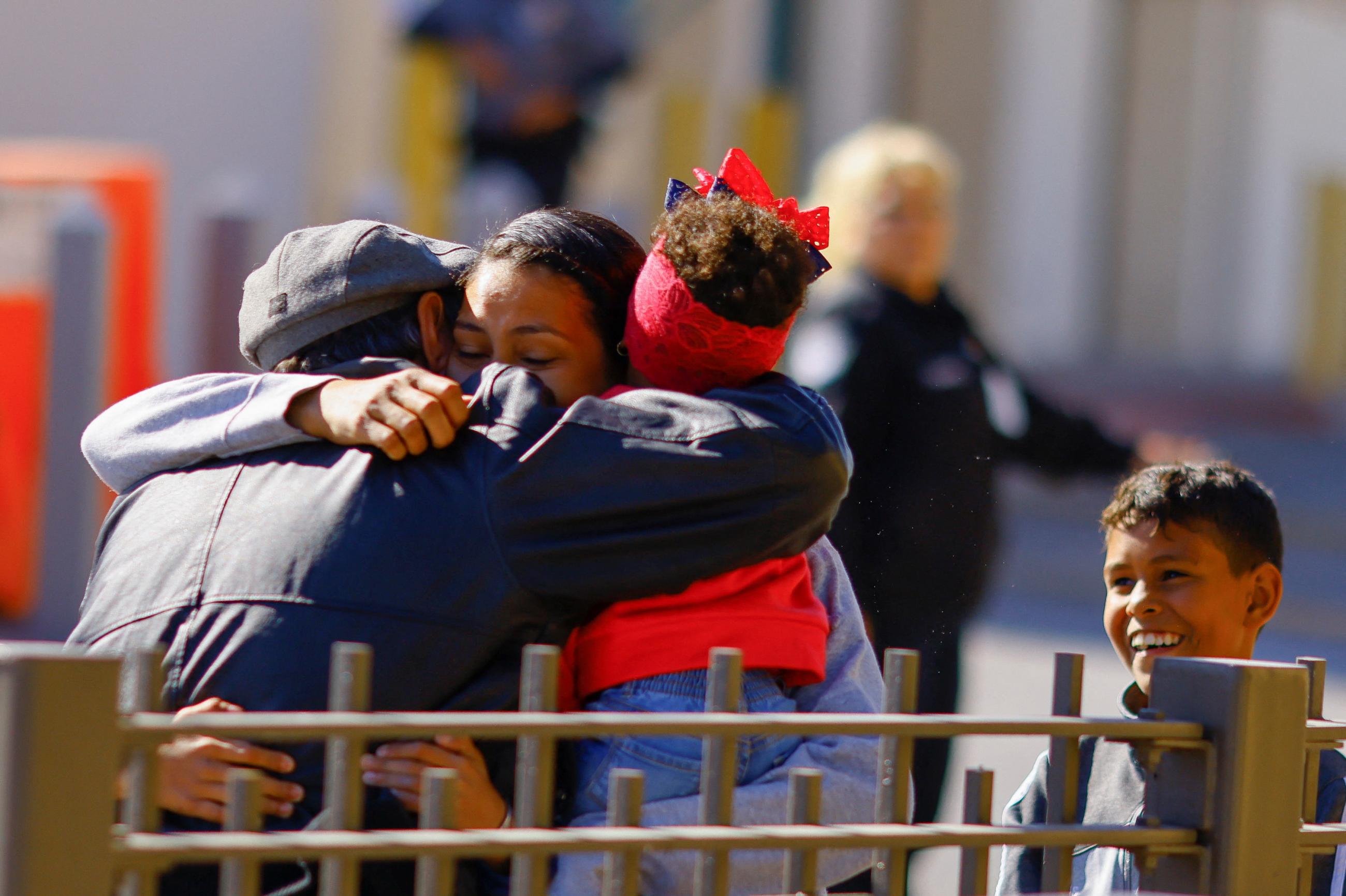 A Venezuelan migrant embraces a person as she enters with her children to the United States to continue her immigration process in El Paso, Texas.