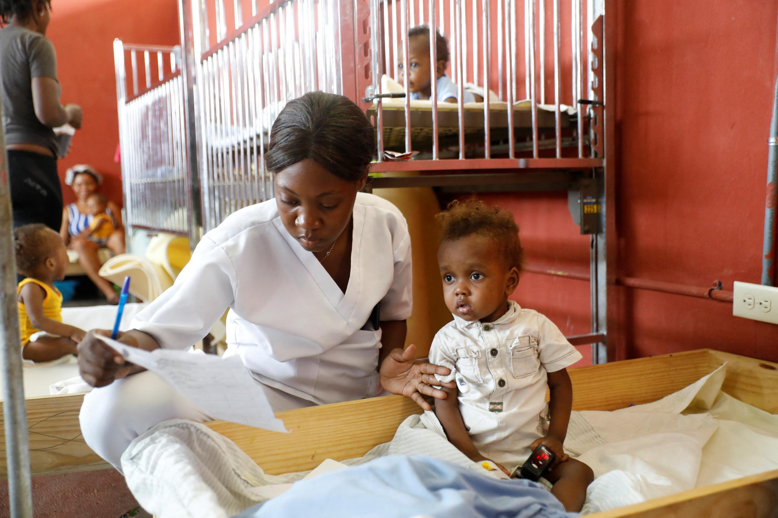 A registered nurse cares for an infant at the Centre Hospitalier de Fontaine.