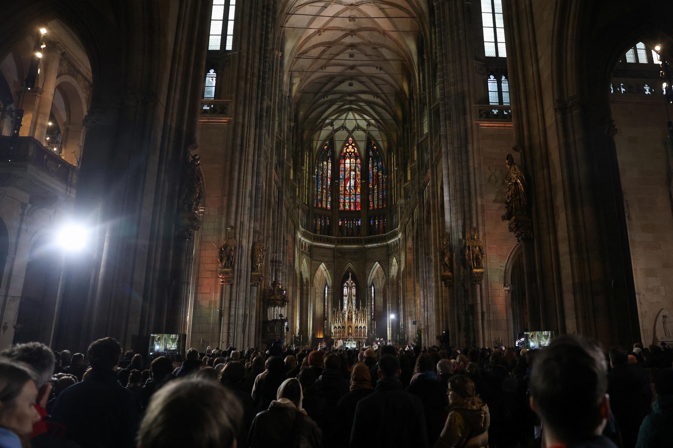 People attend a mass commemorating the victims of a shooting at one of Charles University's buildings, as people observe a national mourning day.