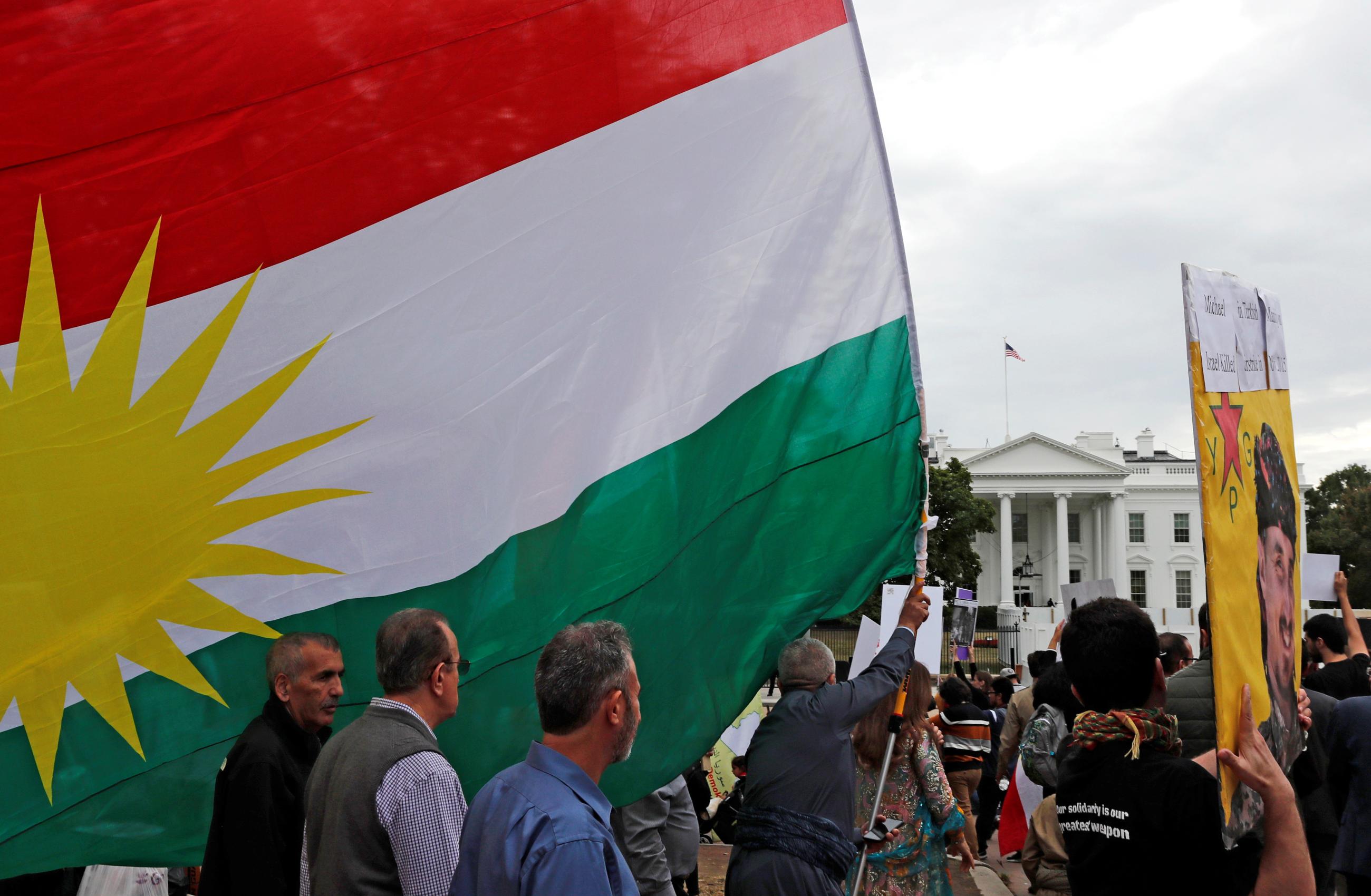 Members of the American Rojava Center for Democracy take part with other activists in a rally to protest Turkey's incursion into Kurdish-controlled northeast Syria and urge U.S. action against Turkey.