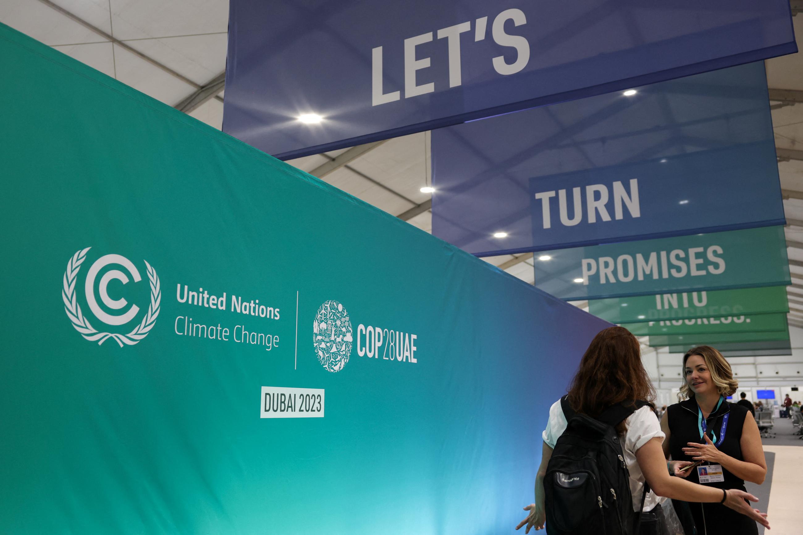 People talk at the venue during COP28.