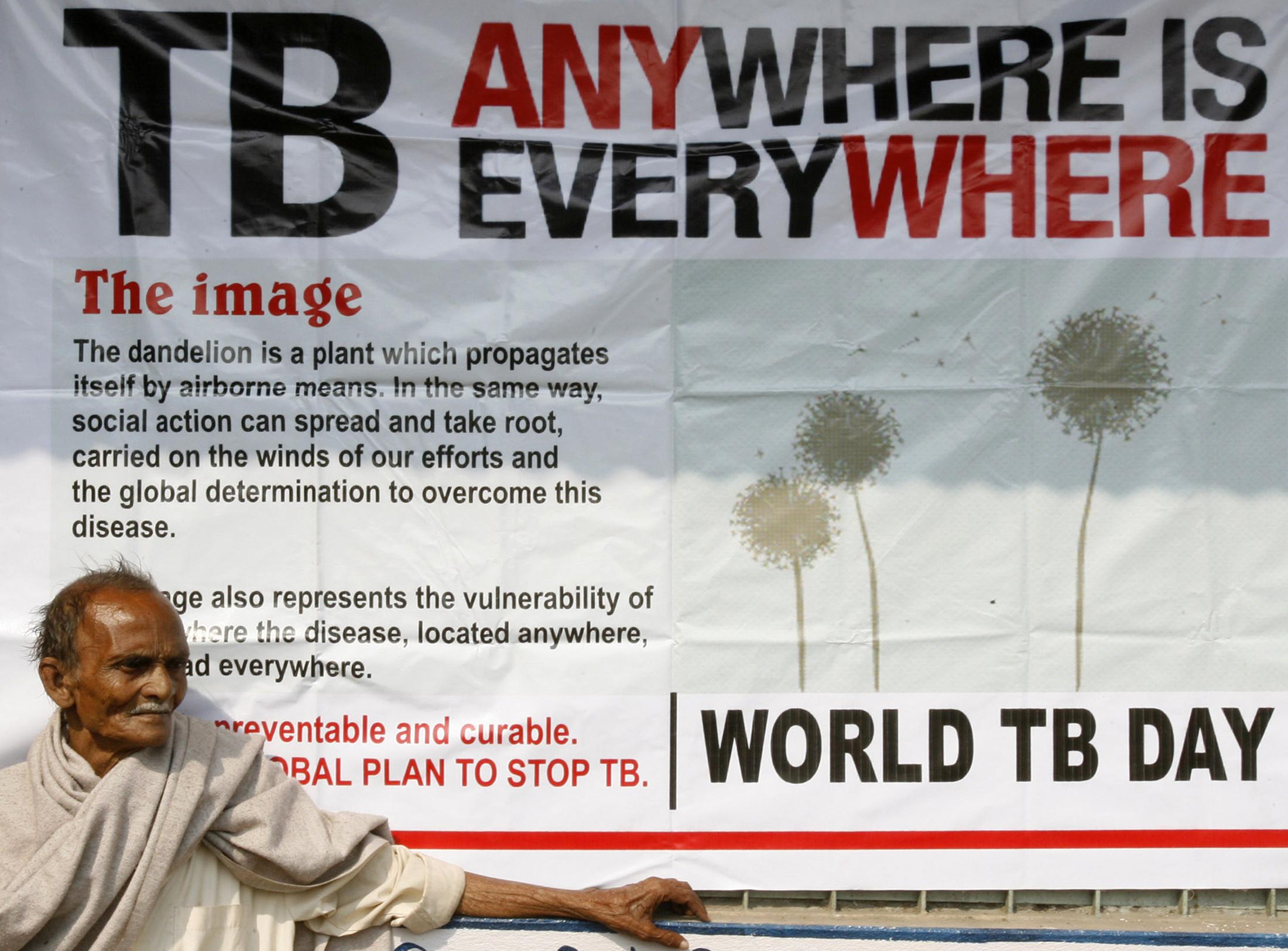 Man living with TB waits for treatment outside a medical center in Siliguri, India, on March 24, 2009.
