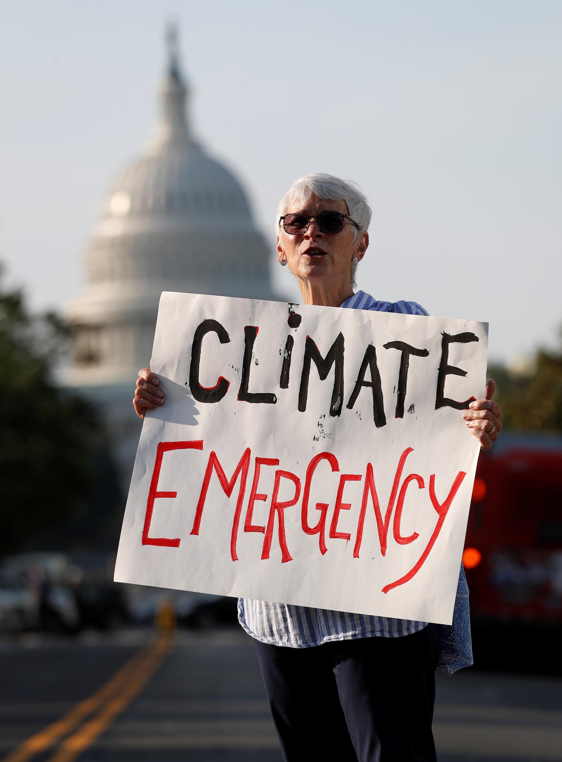 Environmental activists block traffic seeking to pressure U.S. politicians to fight climate change.