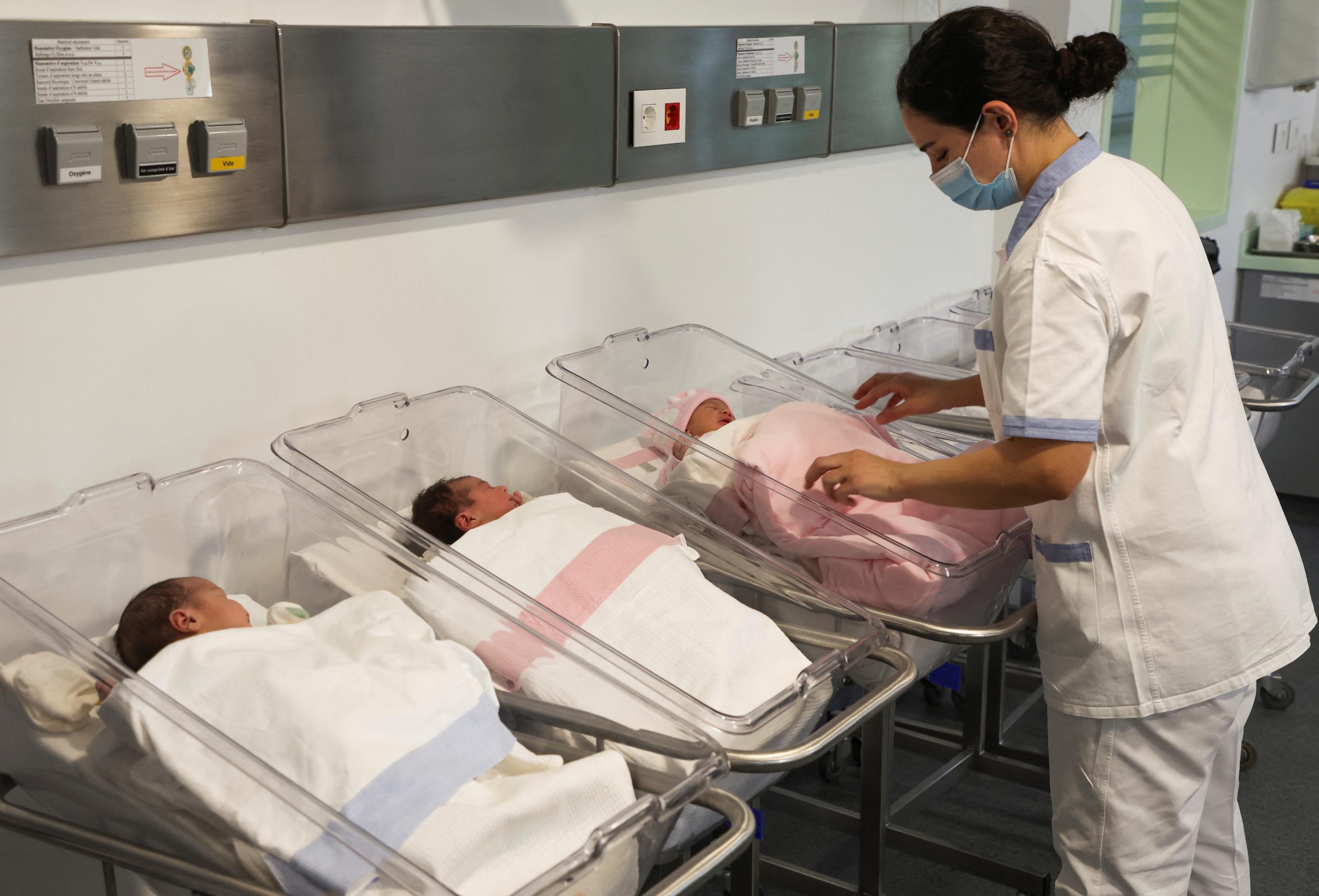 A medical worker stands near newborn babies at Hotel Dieu hospital as the world's population surged past 8 billion, according to the United Nations, in Beirut, Lebanon November 15, 2022.