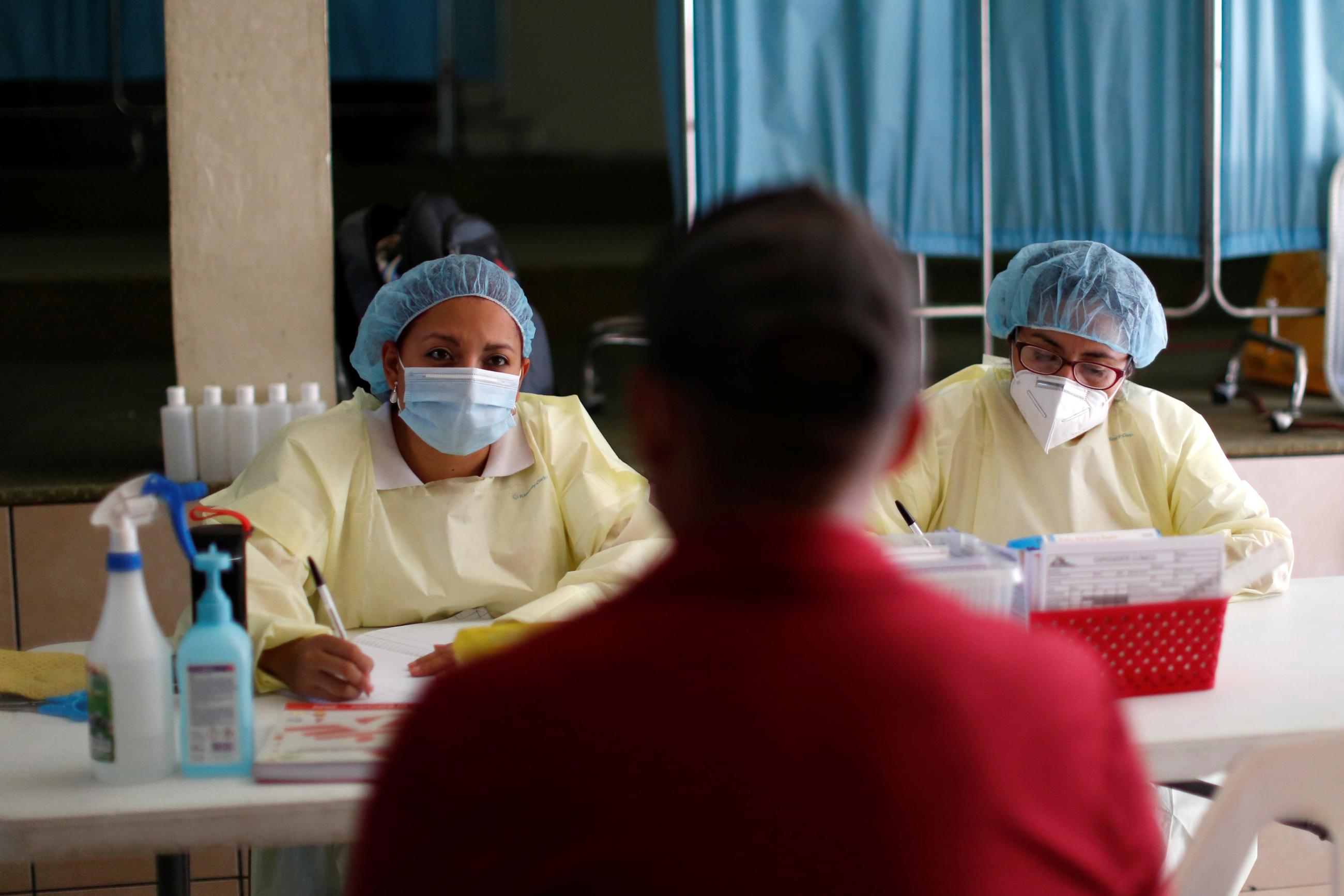 A nurse attends to a man at a mobile clinic.