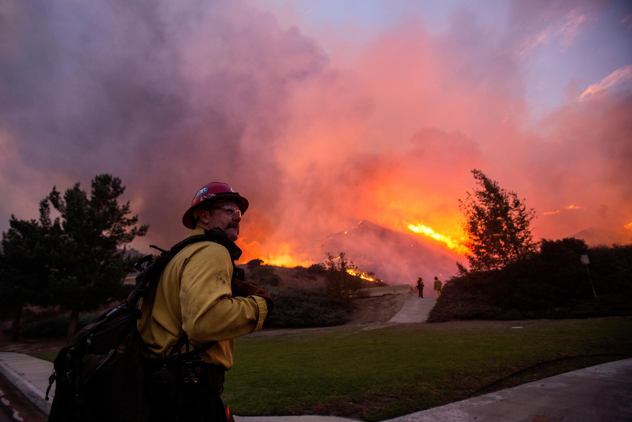 A firefighter watches the Blue Ridge Fire burning in Yorba Linda.