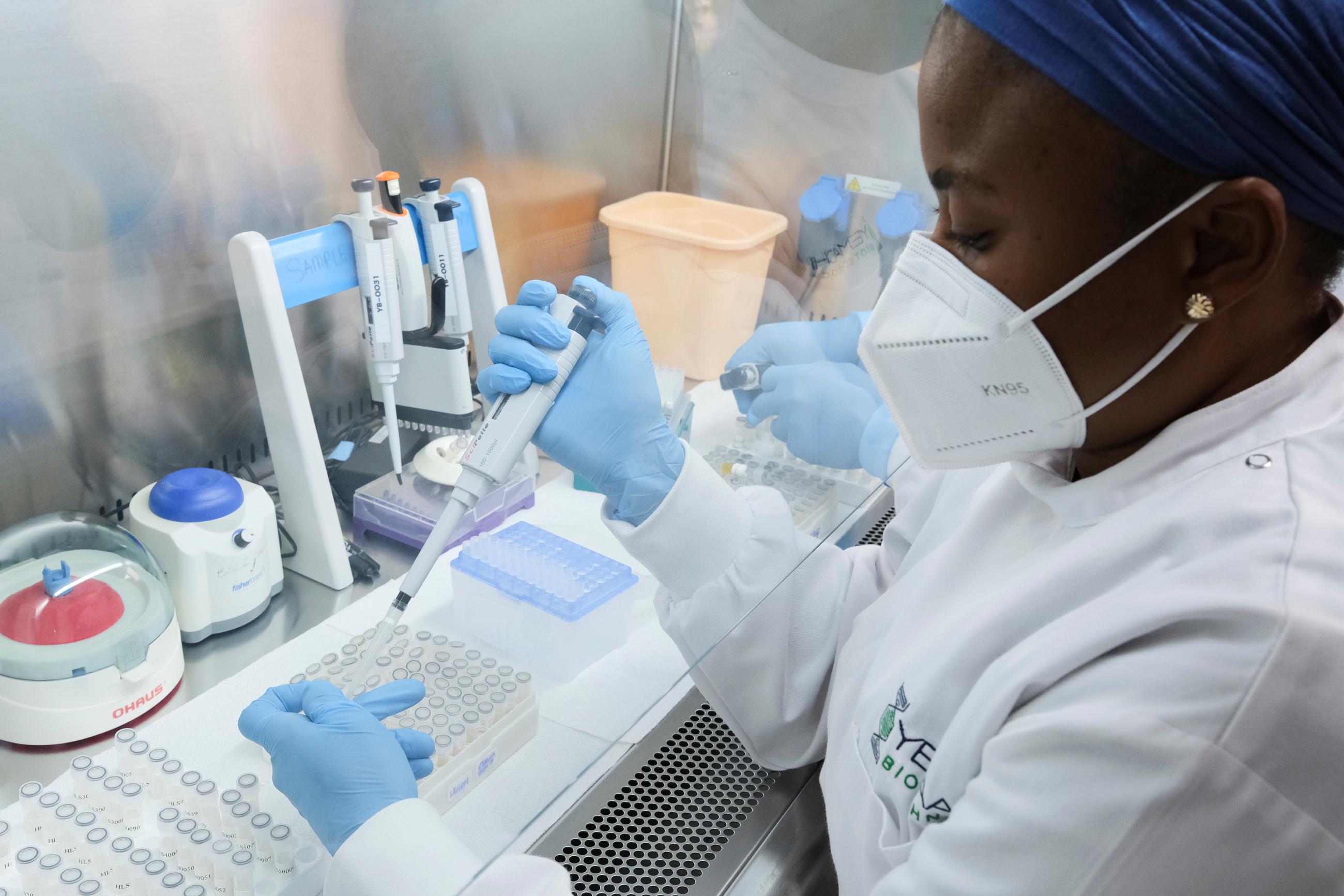 Aisha Mohammed, a research associate, aliquots serum into new tubes at Yemaachi Biotechnology, a cancer research laboratory.