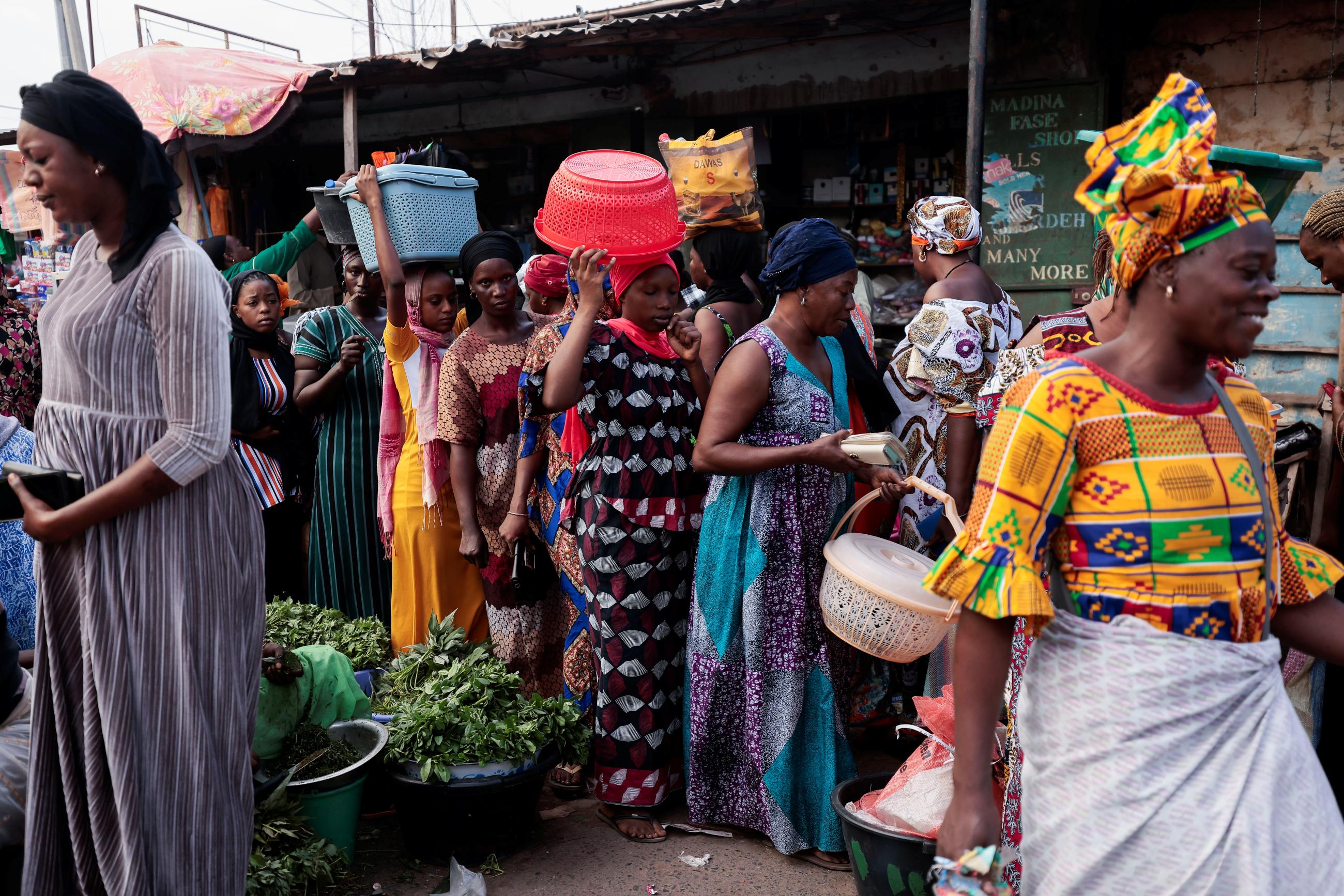 Women shop at a street market ahead of the presidential election in Banjul, Gambia, December 3, 2021.