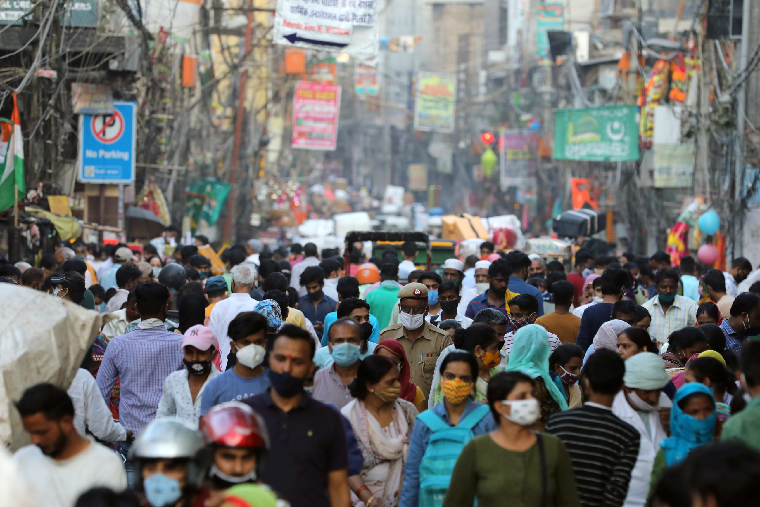 People are seen at a market amid the spread of COVID-19.