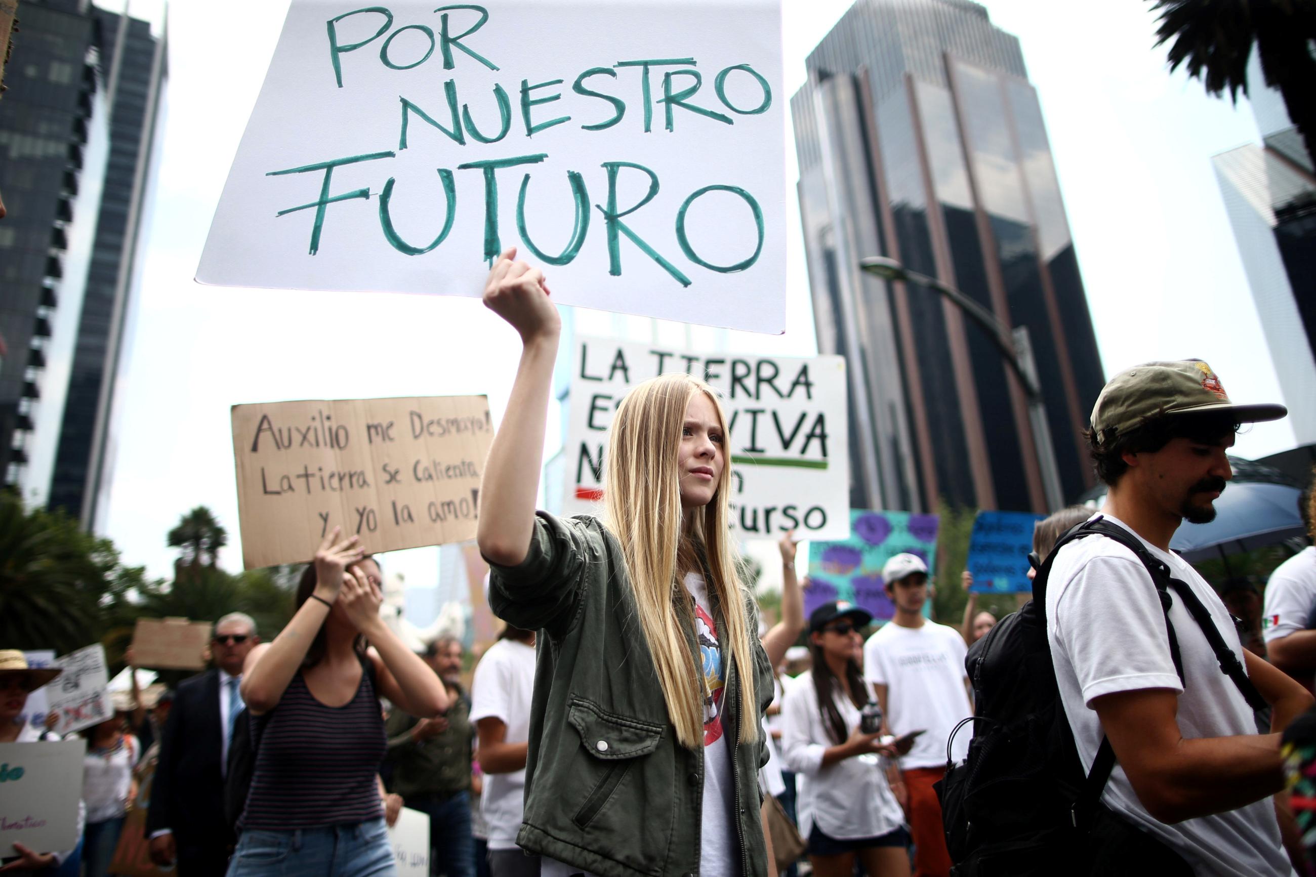 A demonstrator holds a sign that reads “For Our Future” in the world march for climate change and the environment.