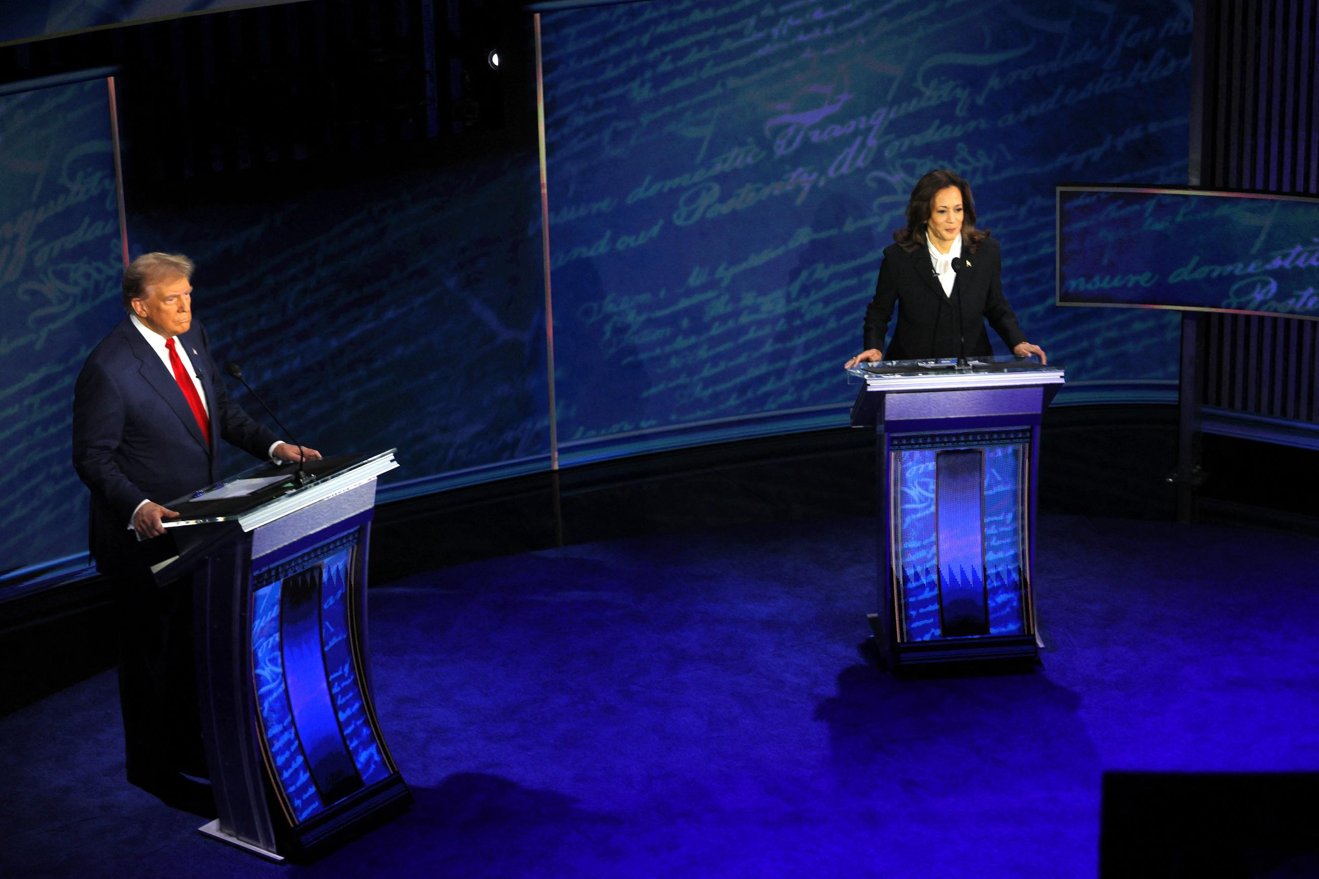 Former U.S. President Donald Trump and U.S. Vice President Kamala Harris attend a presidential debate.