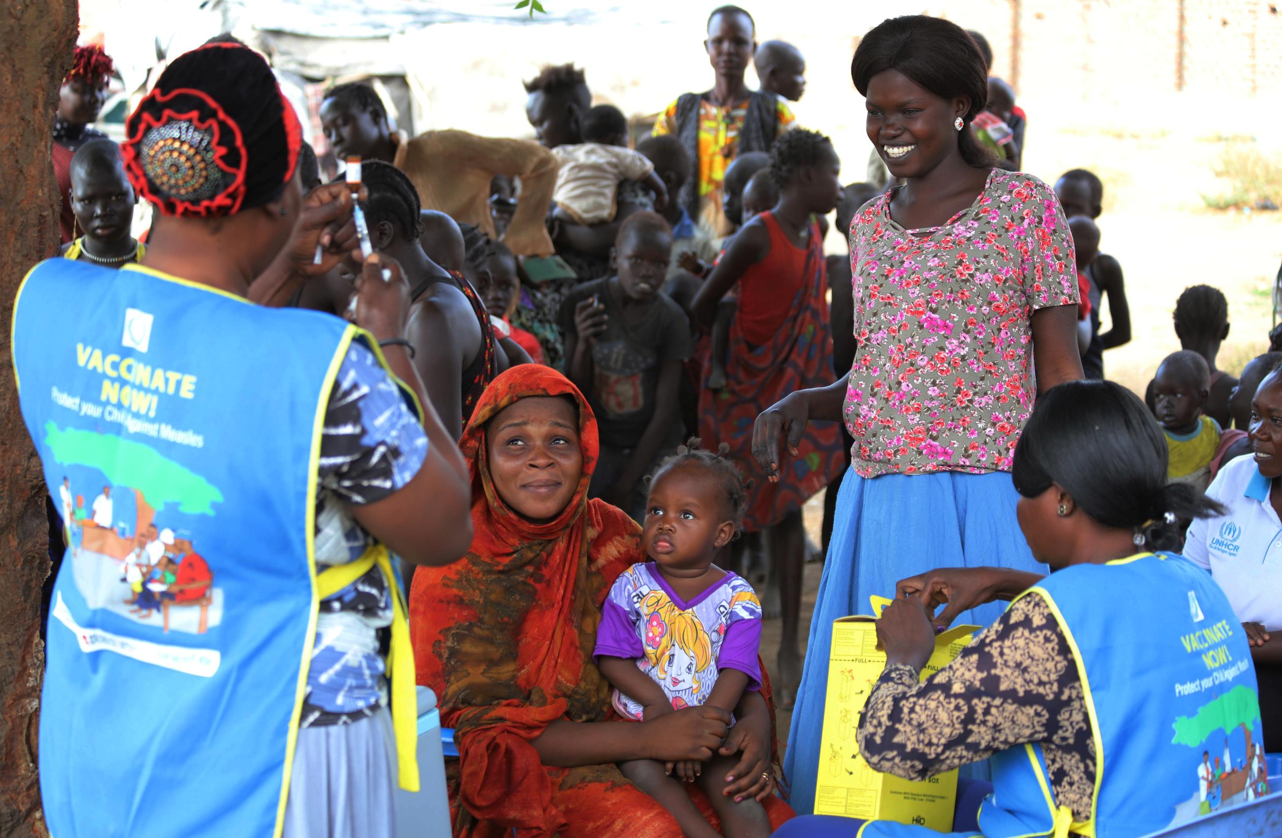 South Sudanese health workers prepare to administer vaccination against measles to children.