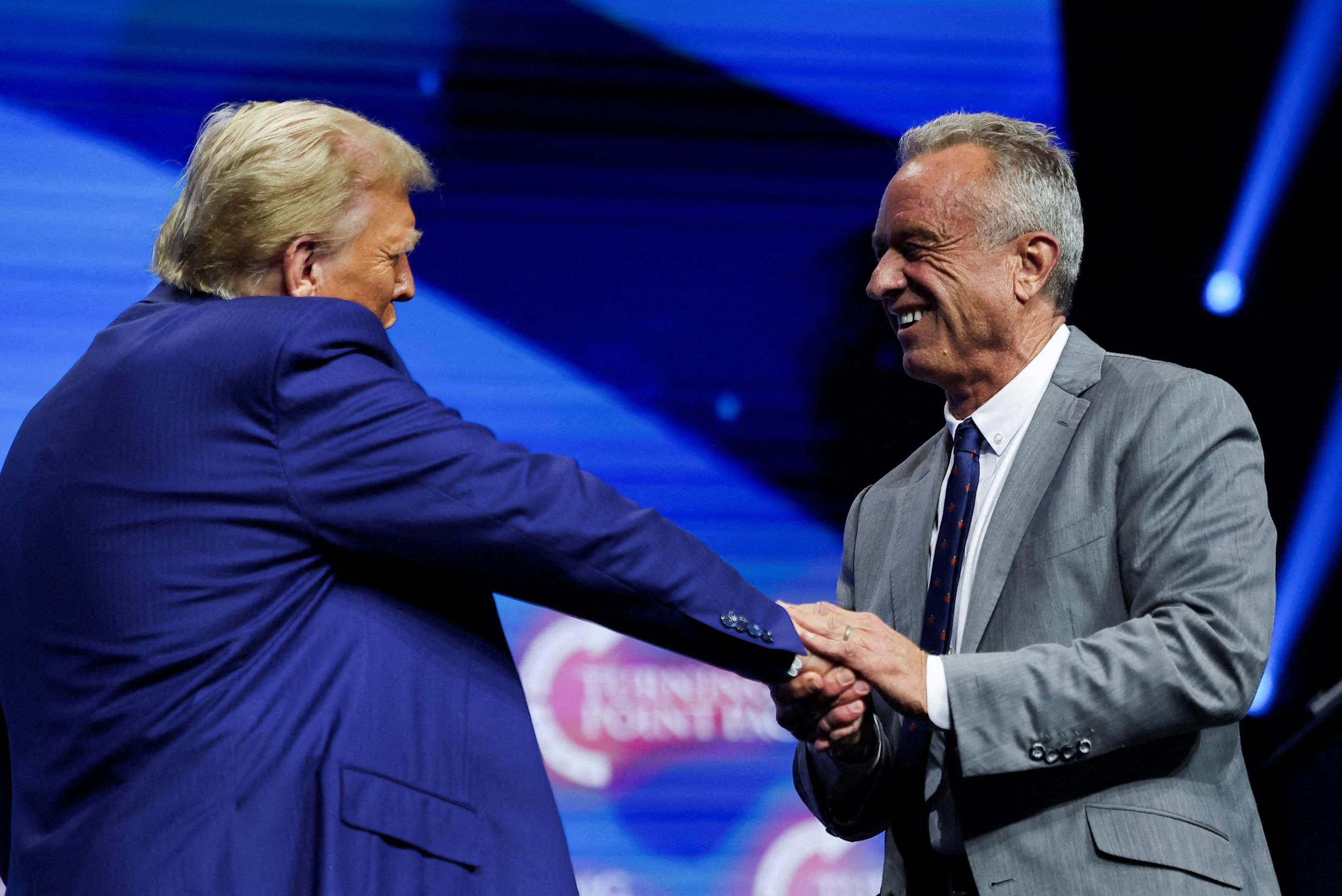  Robert F. Kennedy Jr. and Republican presidential candidate and former U.S. President Donald Trump greet each other at a campaign event sponsored by conservative group Turning Point USA, in Duluth, Georgia, U.S., October 23, 2024. 