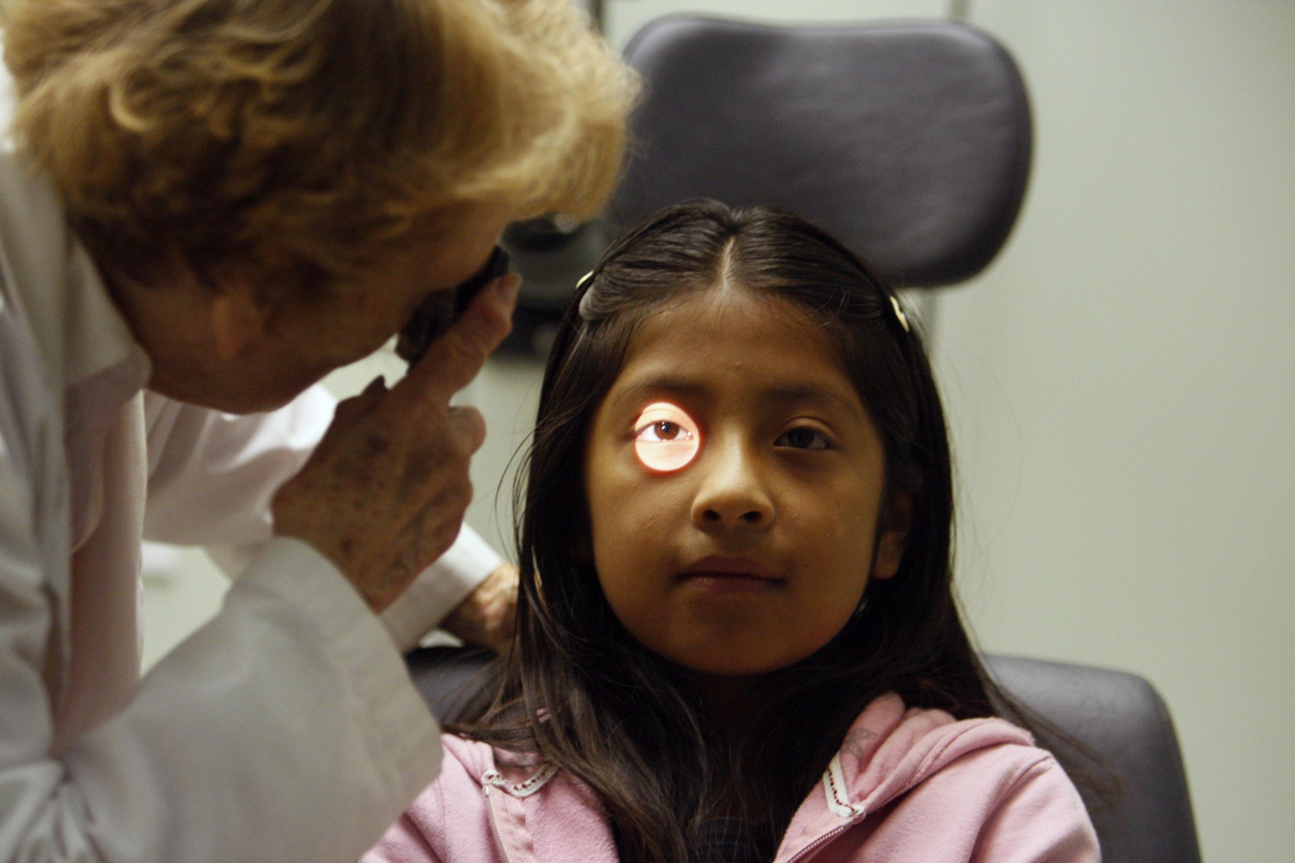 An uninsured patient has an eye test at Venice Family Clinic.