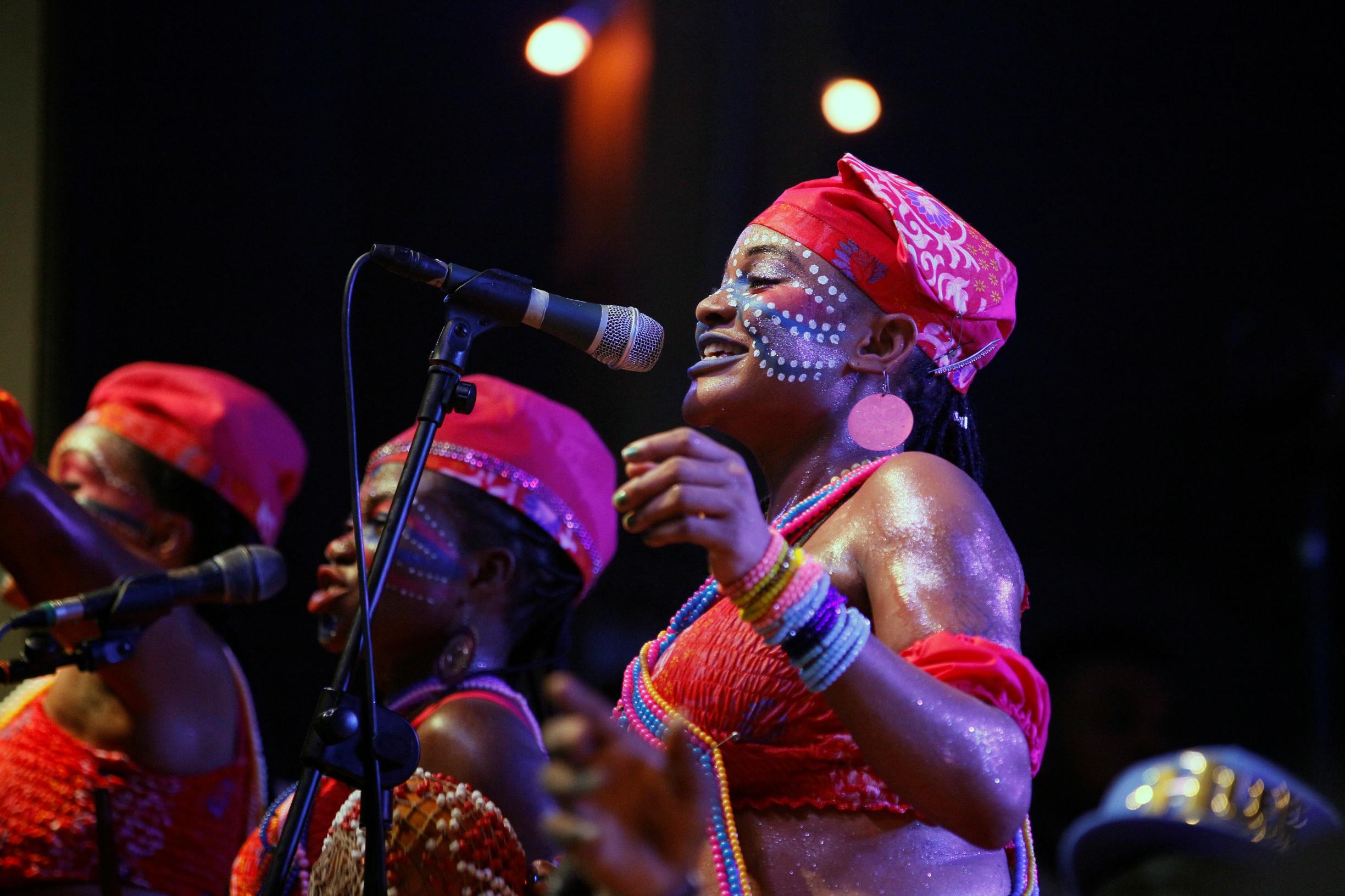 Backup singers perform as Afrobeat musician, Femi Kuti, performs at the annual musical celebration in honor of Fela Kuti.