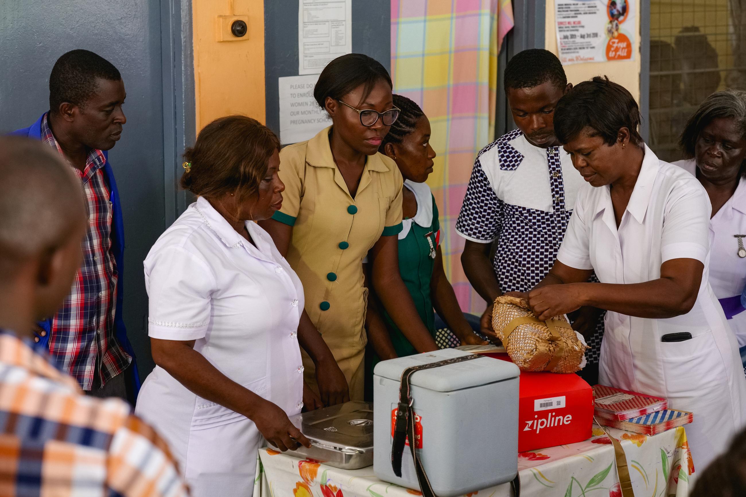 A nurse unpacks a Zipline vaccine delivery.